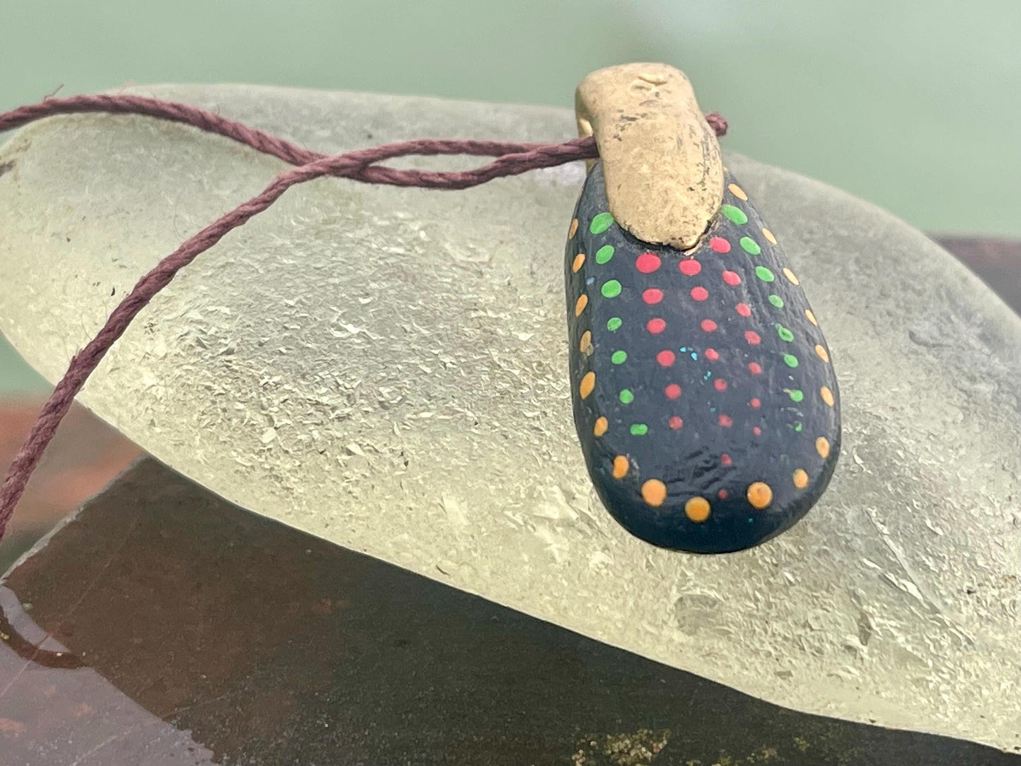 Pebble pendants. Painted pebble necklaces. Hand painted eco friendly necklaces. Eco friendly jewellery. Ethical handmade jewellery.
