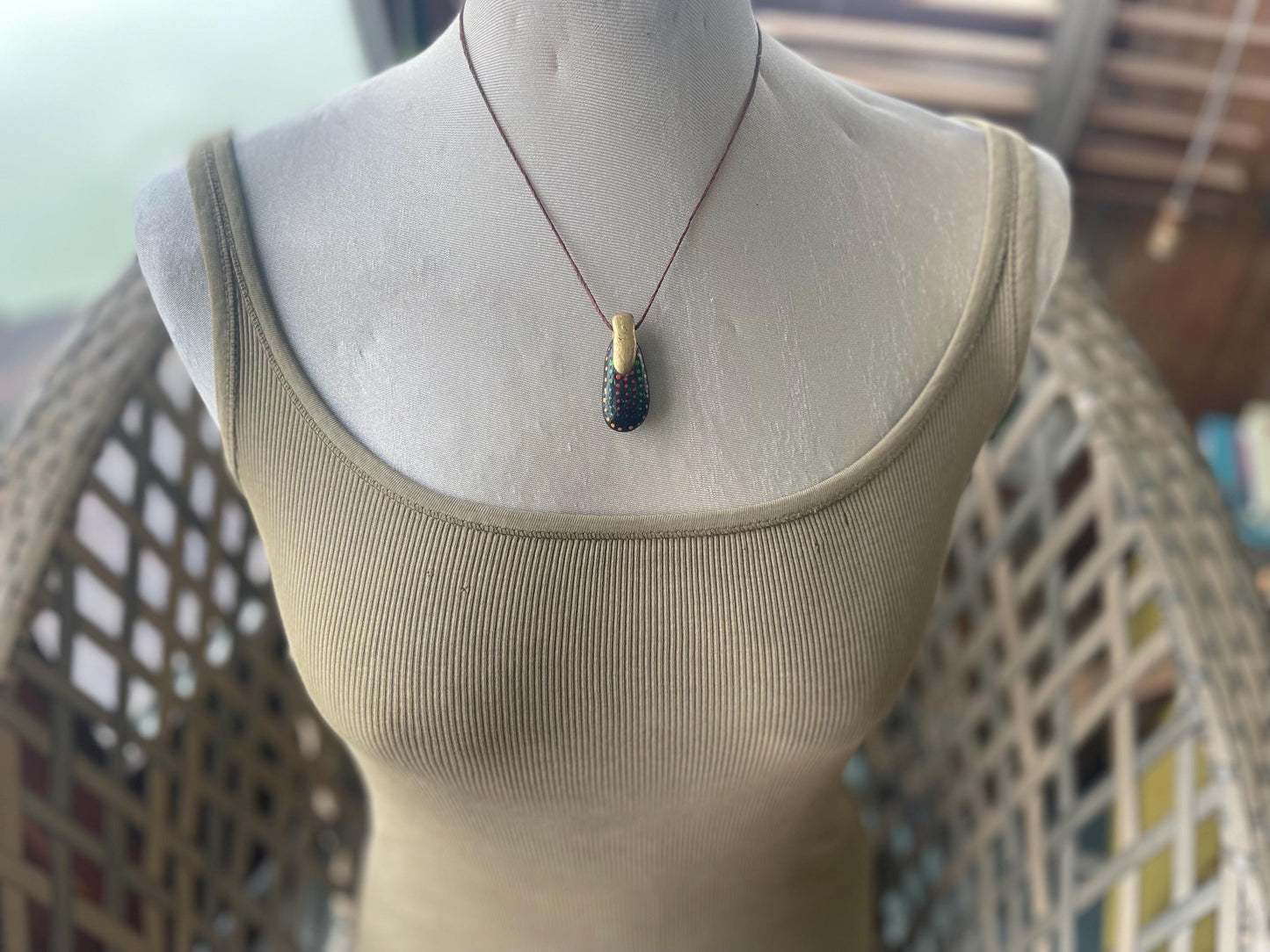 Pebble pendants. Painted pebble necklaces. Hand painted eco friendly necklaces. Eco friendly jewellery. Ethical handmade jewellery.