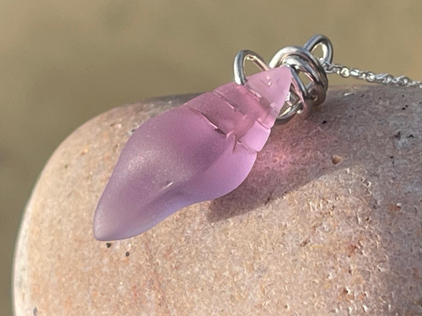 Eco friendly glass necklace on a sterling silver chain showcasing a pink shell pendant. Eco friendly jewellery. Ethical handmade jewellery