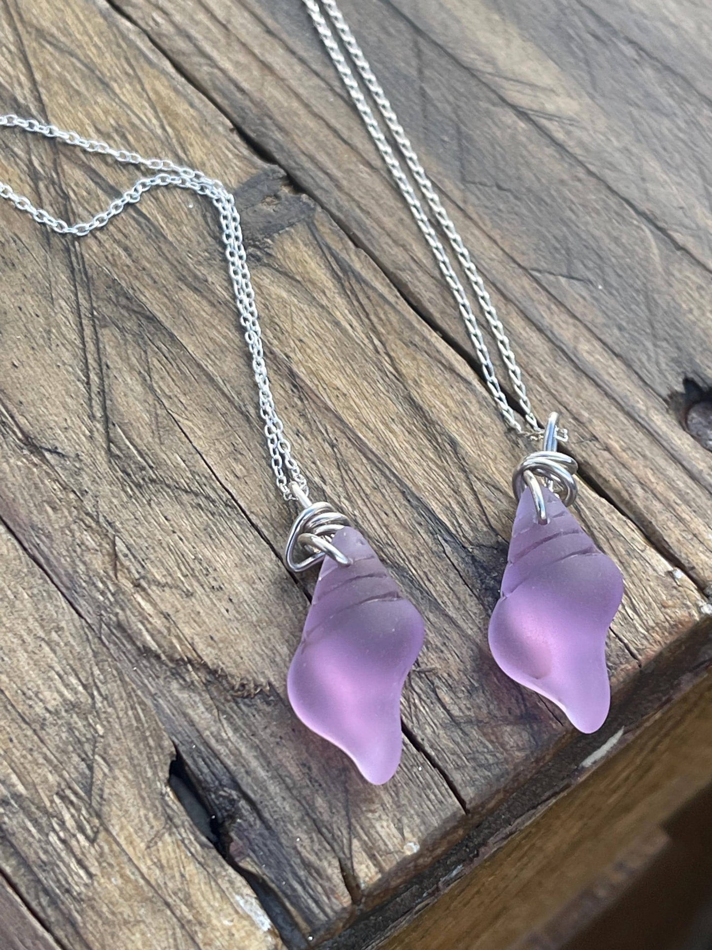 Eco friendly glass necklace on a sterling silver chain showcasing a pink shell pendant. Eco friendly jewellery. Ethical handmade jewellery
