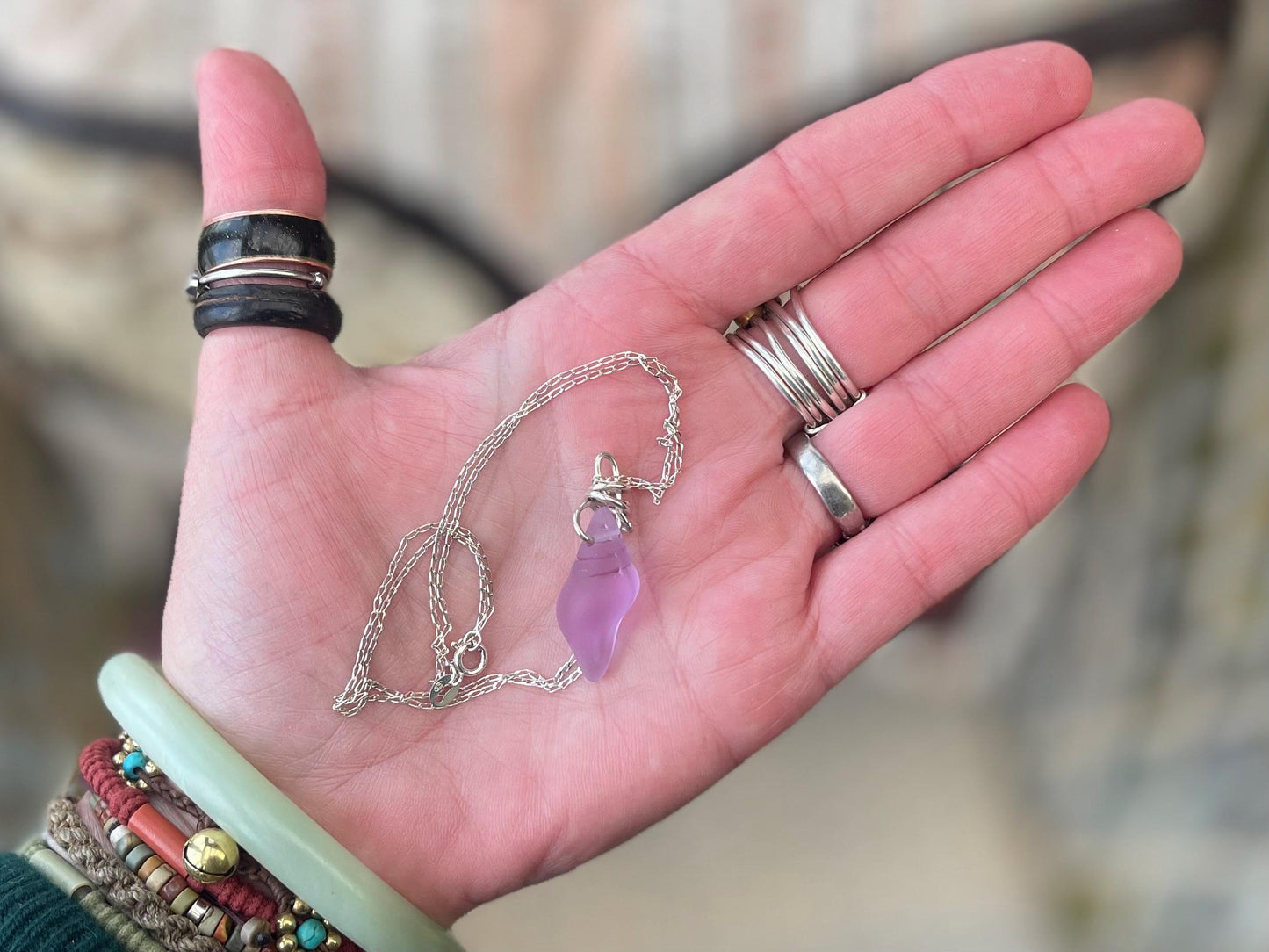 Eco friendly glass necklace on a sterling silver chain showcasing a pink shell pendant. Eco friendly jewellery. Ethical handmade jewellery