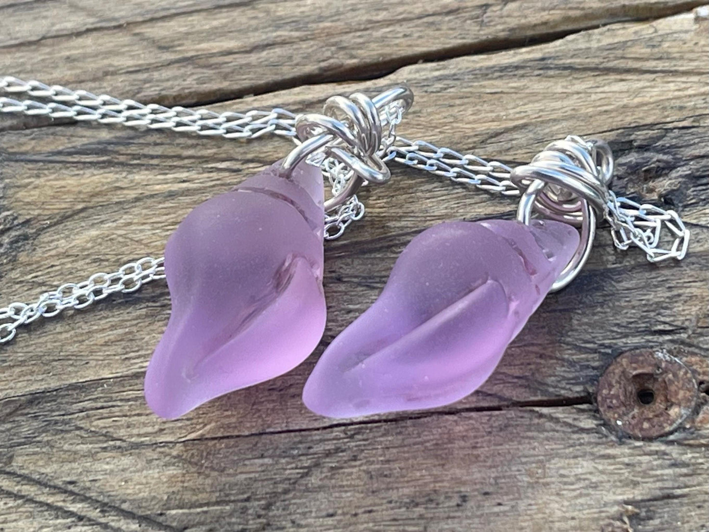 Eco friendly glass necklace on a sterling silver chain showcasing a pink shell pendant. Eco friendly jewellery. Ethical handmade jewellery