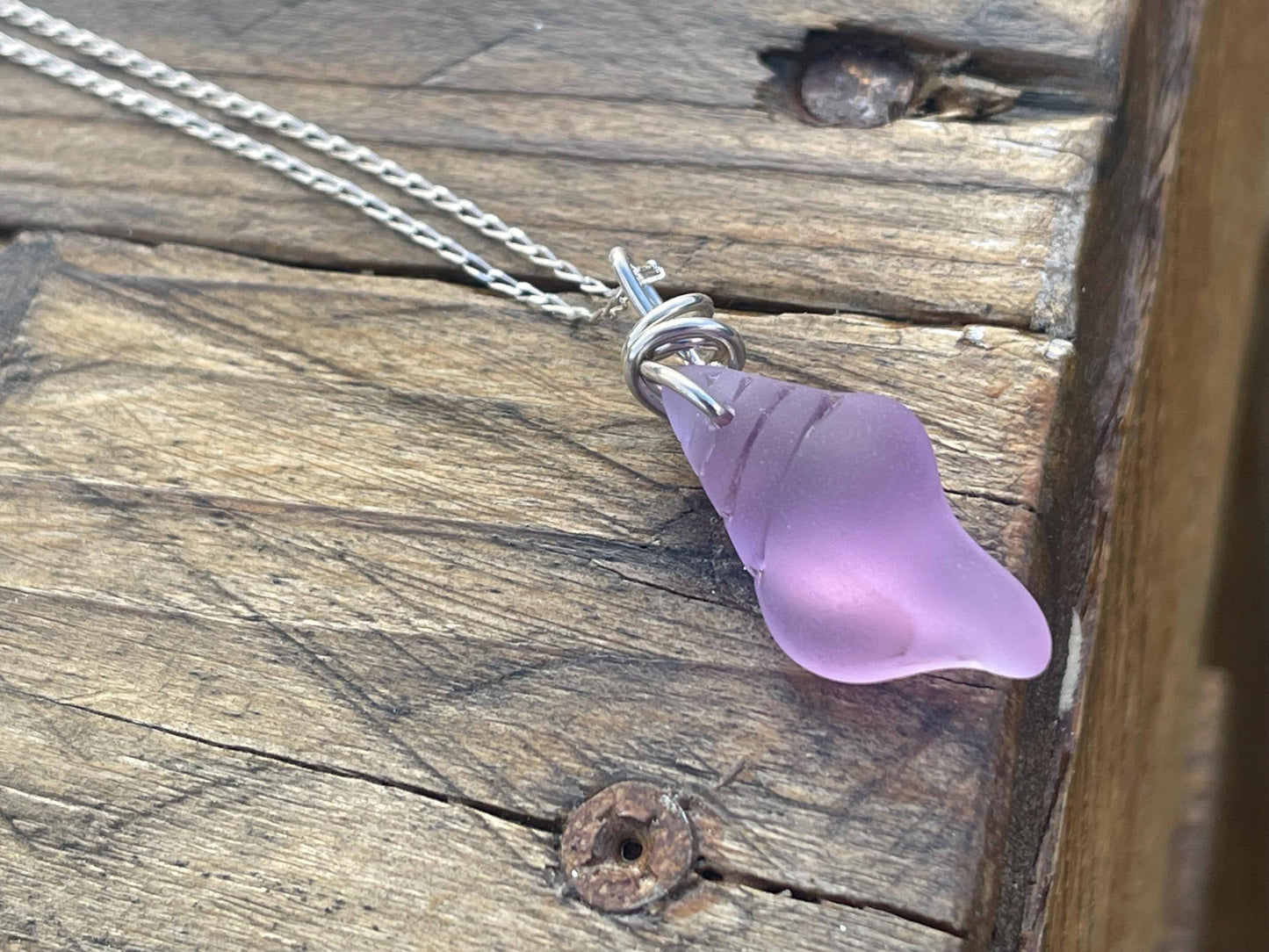 Eco friendly glass necklace on a sterling silver chain showcasing a pink shell pendant. Eco friendly jewellery. Ethical handmade jewellery