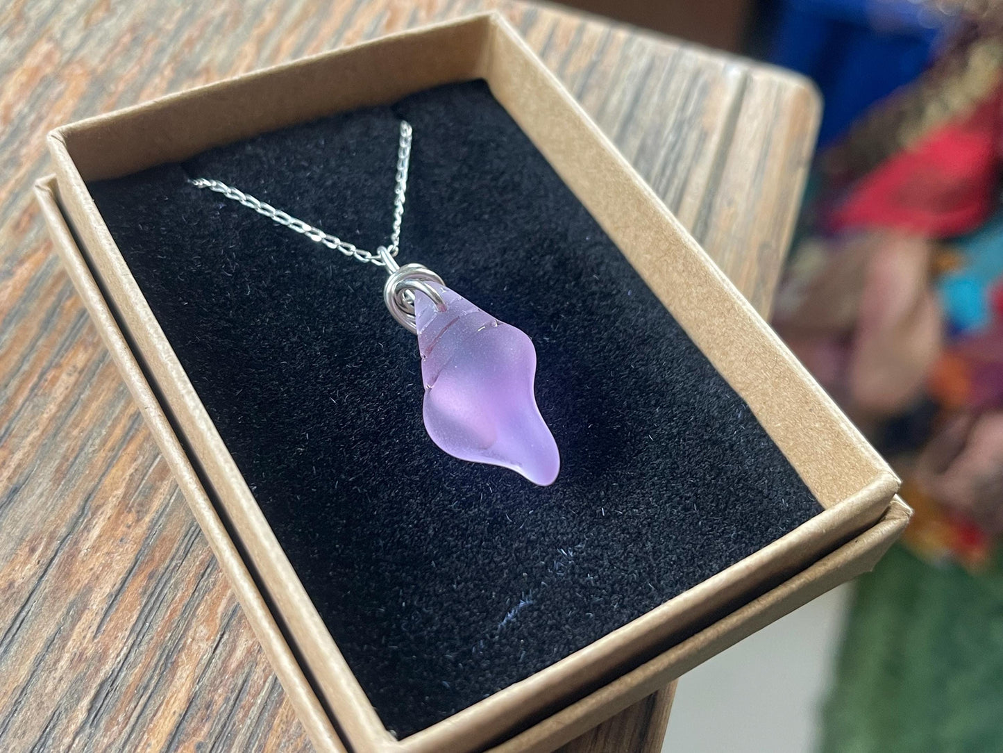 Eco friendly glass necklace on a sterling silver chain showcasing a pink shell pendant. Eco friendly jewellery. Ethical handmade jewellery