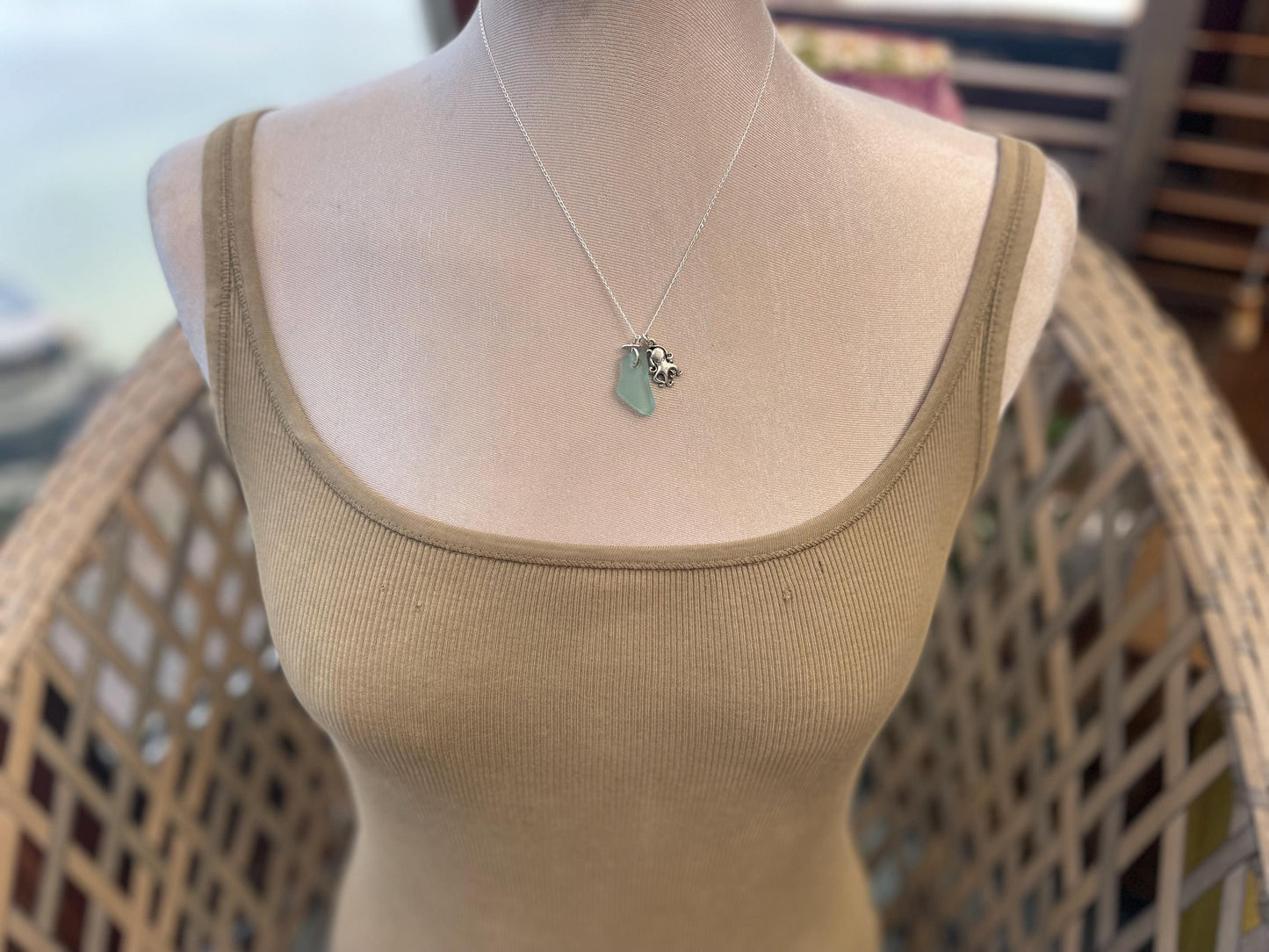 Eco friendly aqua sea glass necklace on a sterling silver chain showcasing a little octopus. Octopus pendant, eco friendly jewellery.