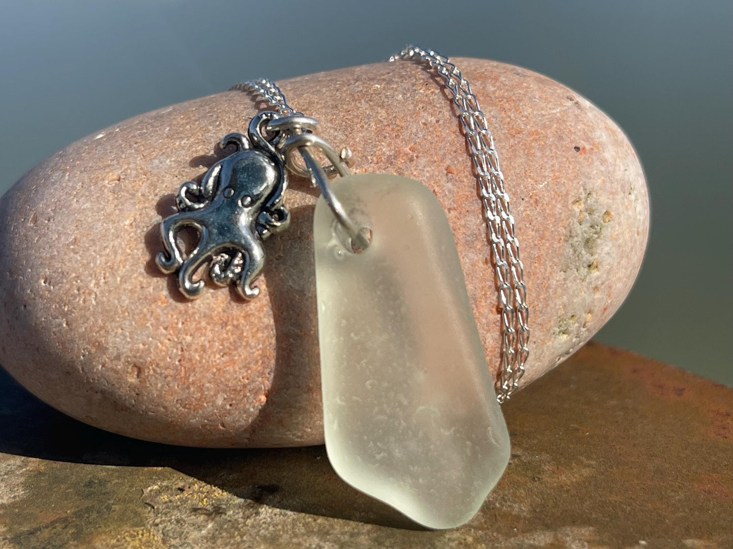 Eco friendly sea glass necklace on a sterling silver chain showcasing a little octopus. Octopus pendant, eco friendly jewellery.