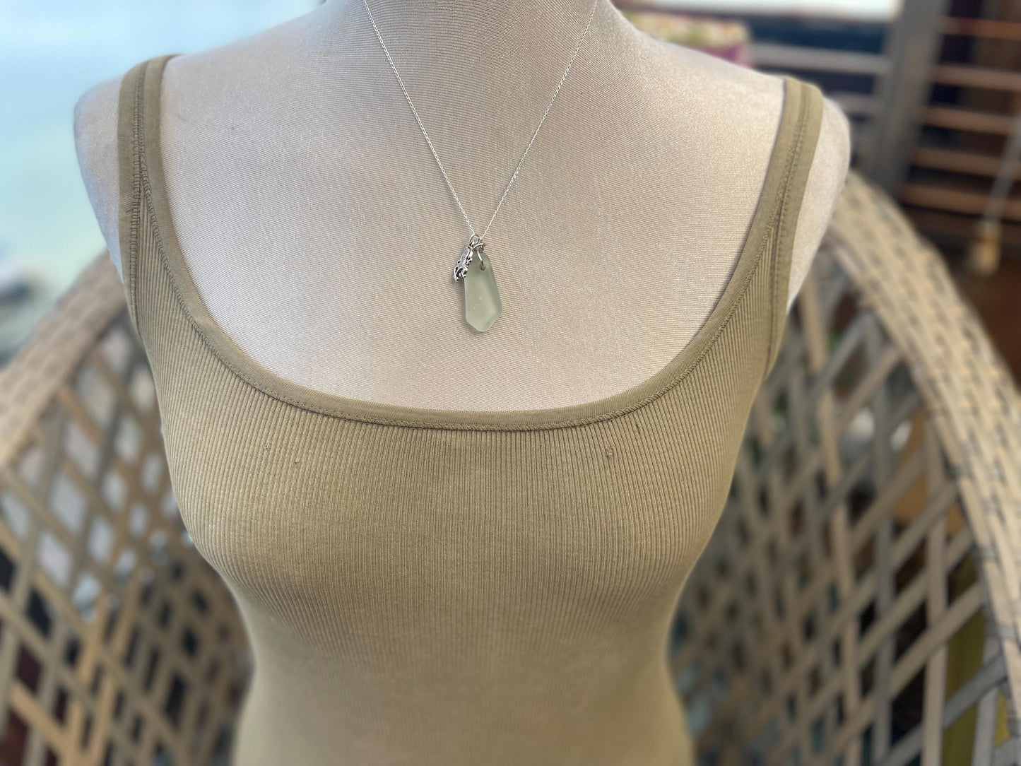 Eco friendly sea glass necklace on a sterling silver chain showcasing a little octopus. Octopus pendant, eco friendly jewellery.