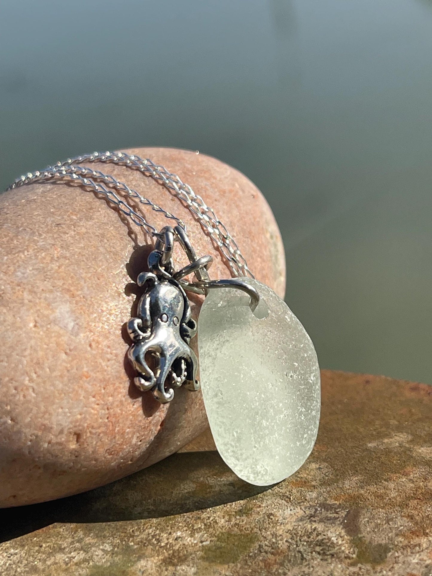 Eco friendly aqua sea glass necklace on a sterling silver chain showcasing a little octopus. Octopus pendant, eco friendly jewellery.