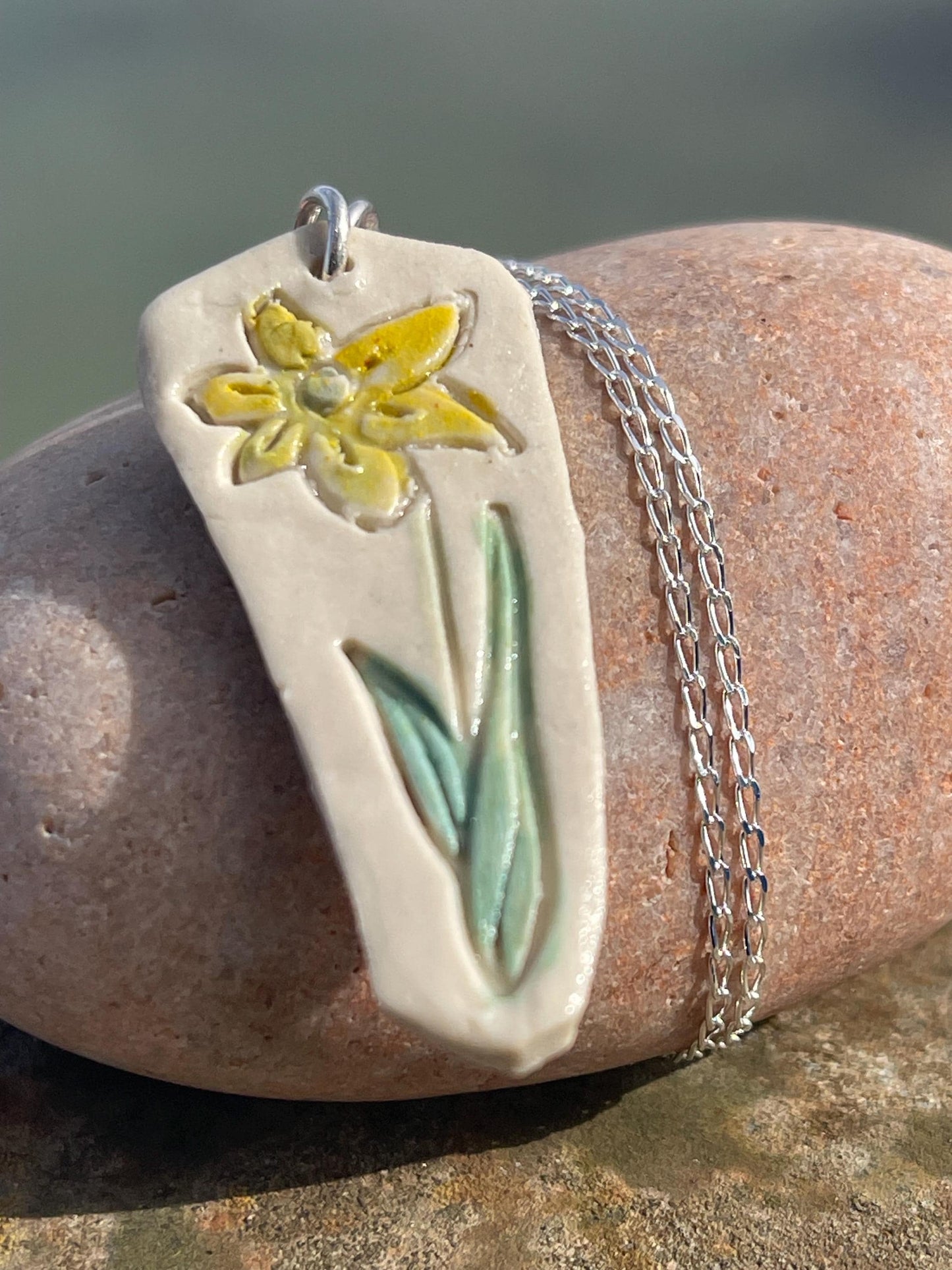 Handmade daffodil necklace. Eco friendly jewellery. Ethical pendants made with waste clay and recycled sterling silver. Ethical jewellery.