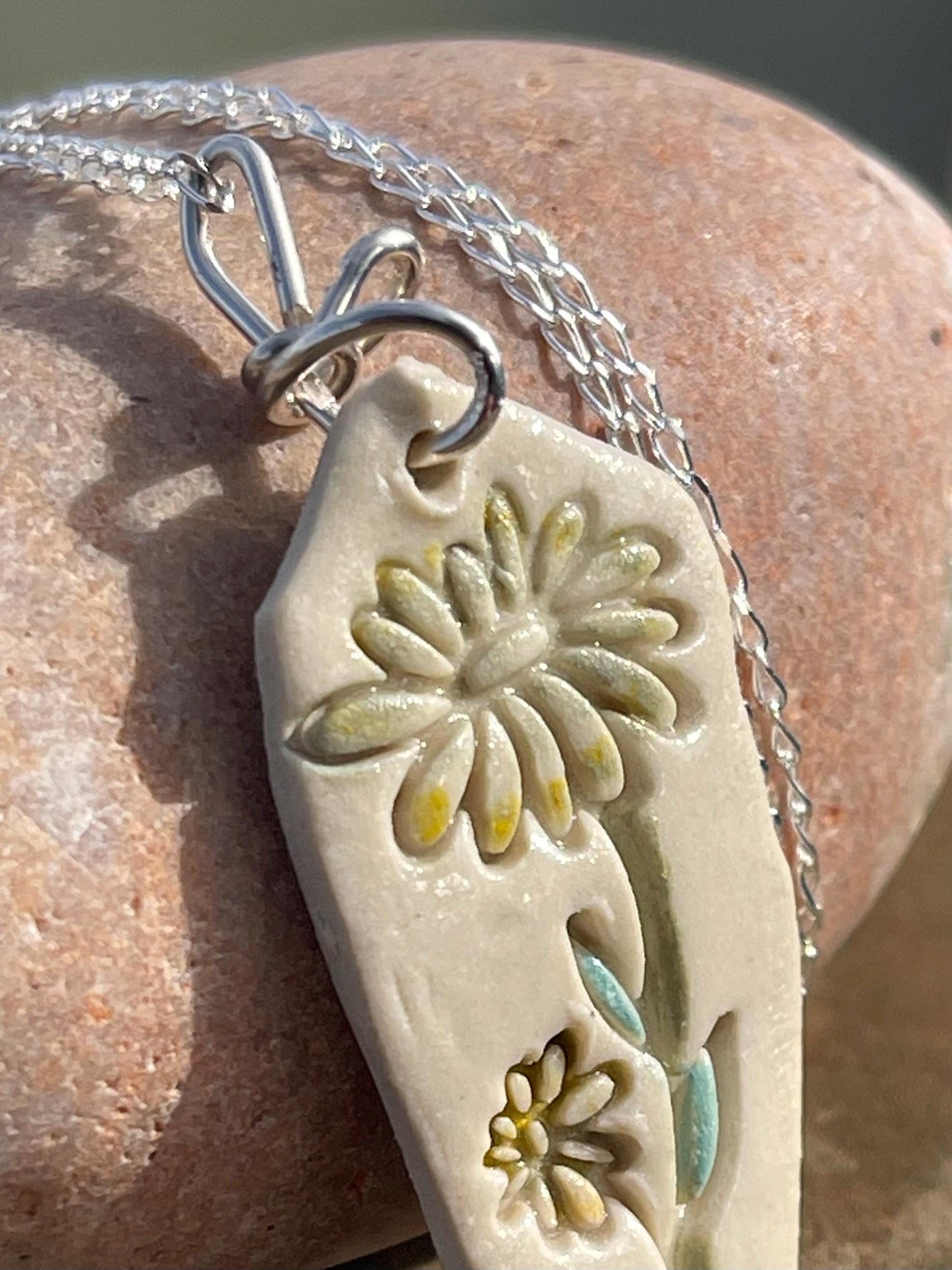 Handmade daisy necklace. Eco friendly jewellery. Ethical pendants made with waste clay and recycled sterling silver. Ethical jewellery.