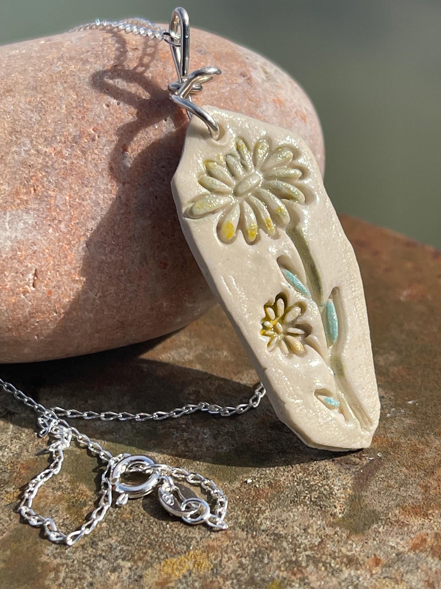 Handmade daisy necklace. Eco friendly jewellery. Ethical pendants made with waste clay and recycled sterling silver. Ethical jewellery.