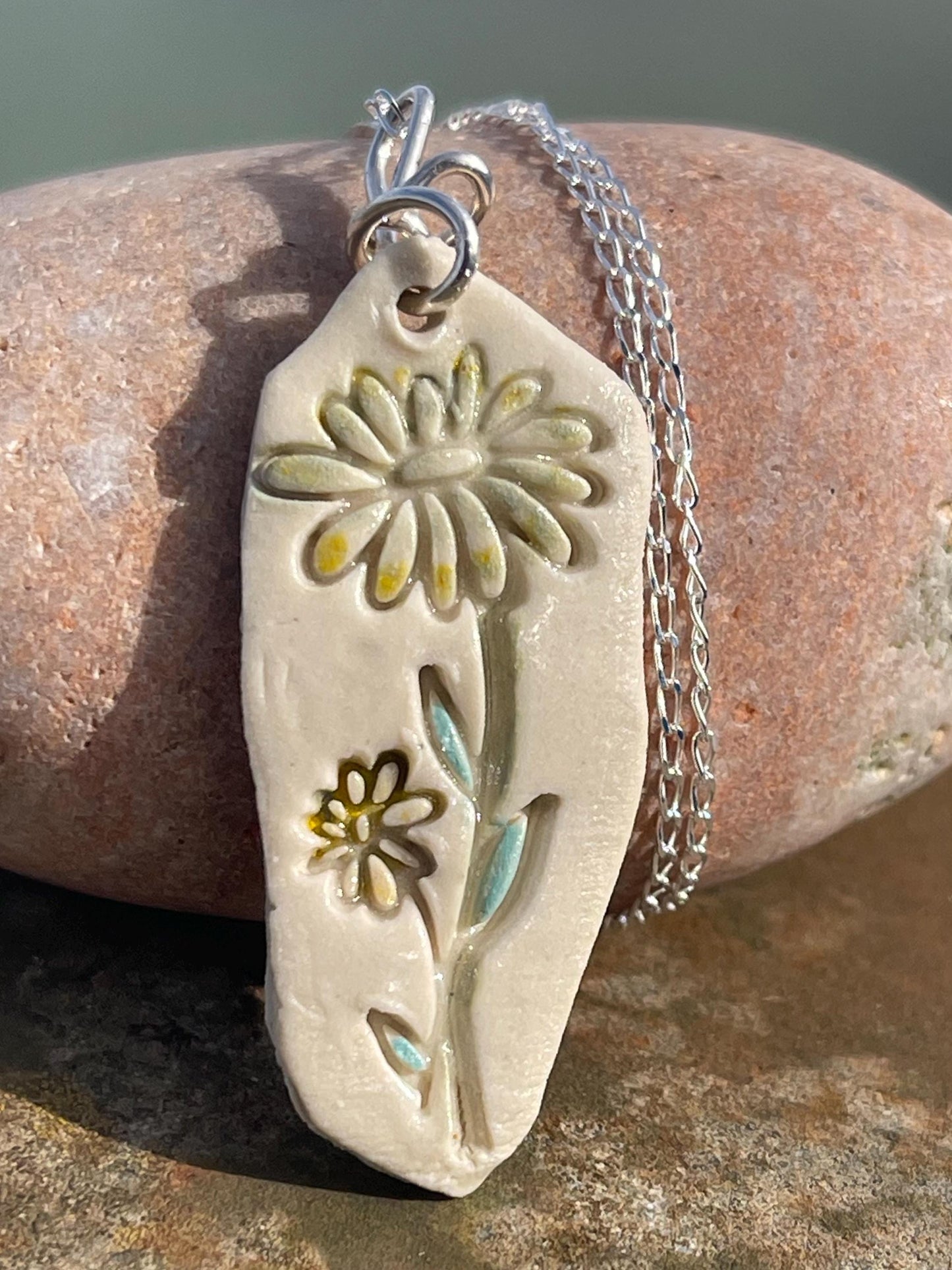 Handmade daisy necklace. Eco friendly jewellery. Ethical pendants made with waste clay and recycled sterling silver. Ethical jewellery.