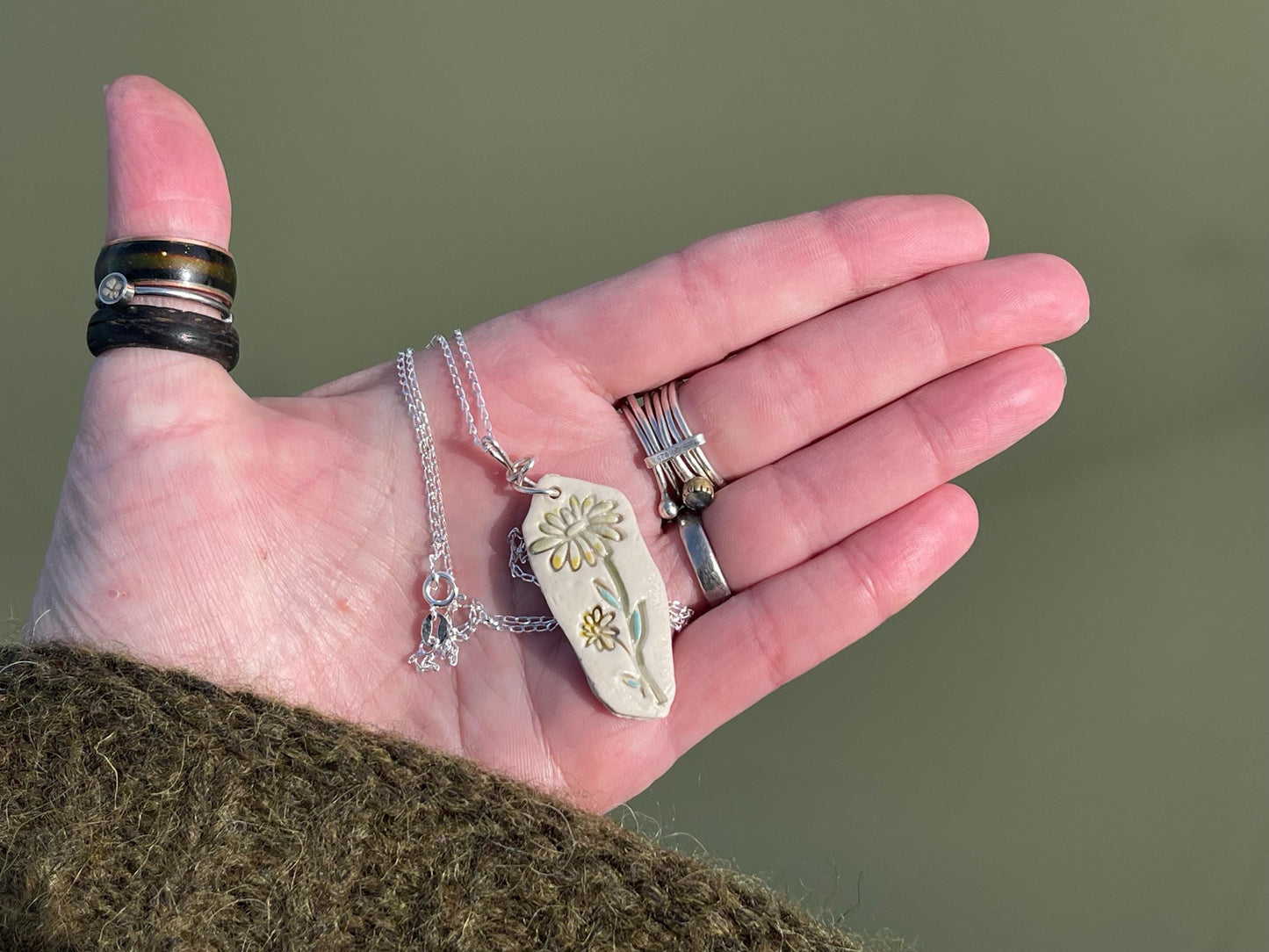 Handmade daisy necklace. Eco friendly jewellery. Ethical pendants made with waste clay and recycled sterling silver. Ethical jewellery.