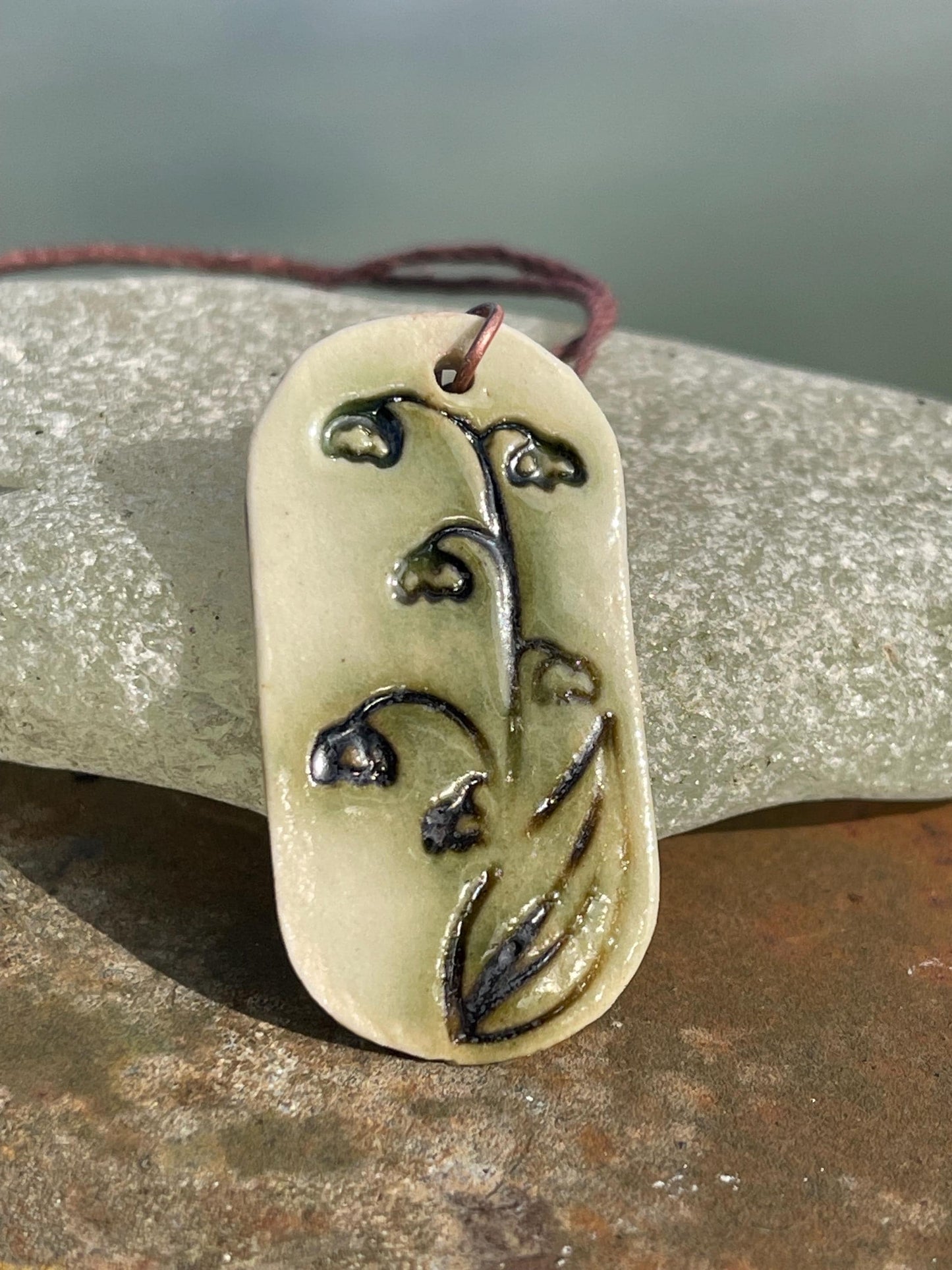 Handmade snowdrop necklace. Eco friendly jewellery. Ethical pendants made with waste clay and burnt recycled copper. Ethical jewellery.