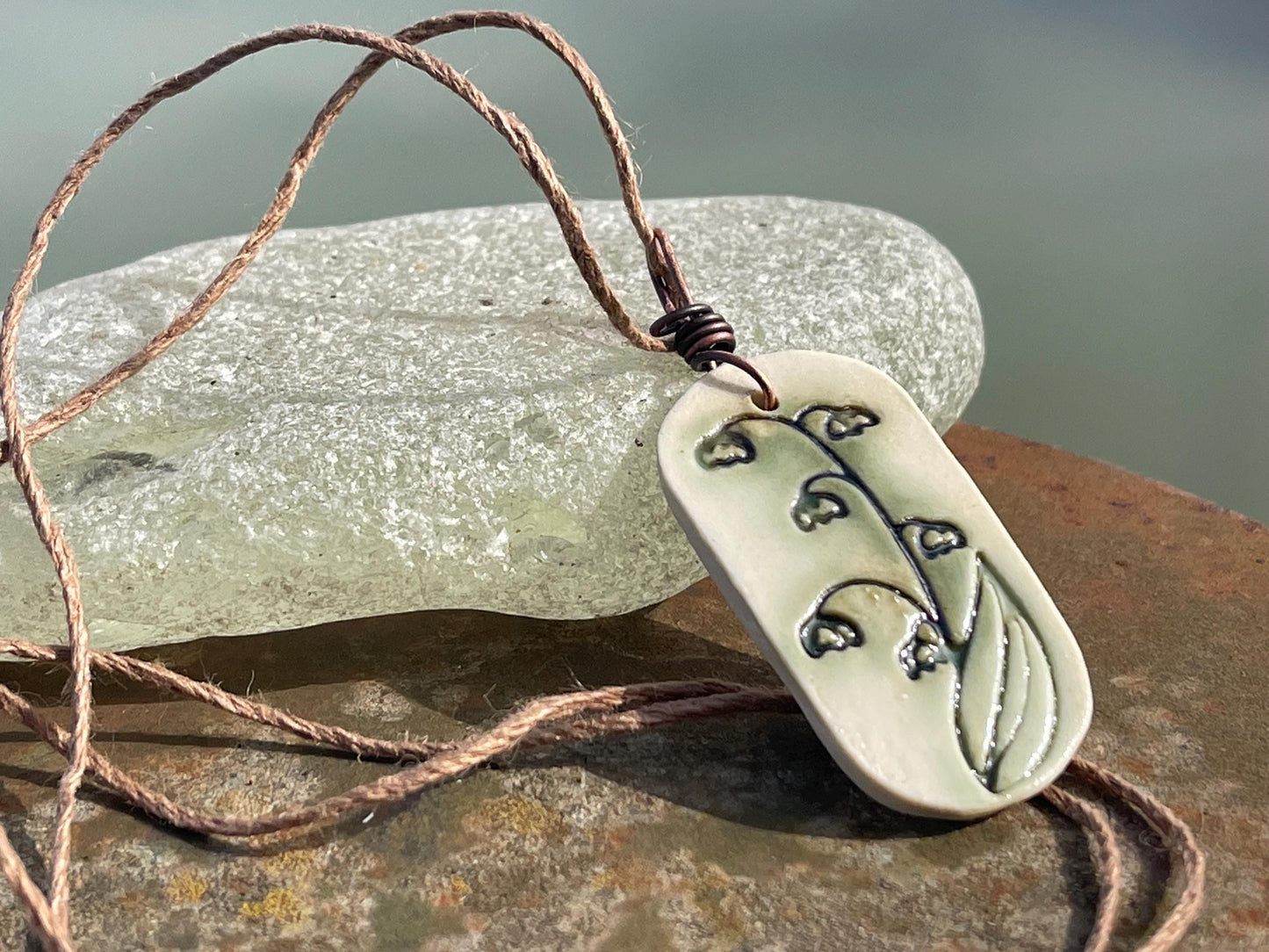 Handmade snowdrop necklace. Eco friendly jewellery. Ethical pendants made with waste clay and burnt recycled copper. Ethical jewellery.