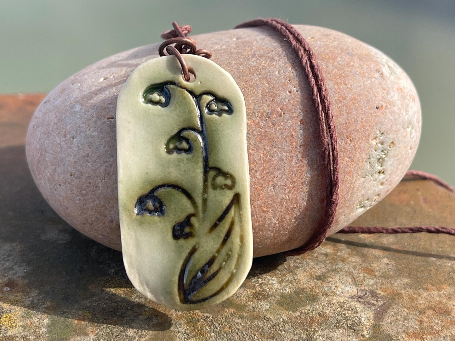 Handmade snowdrop necklace. Eco friendly jewellery. Ethical pendants made with waste clay and burnt recycled copper. Ethical jewellery.