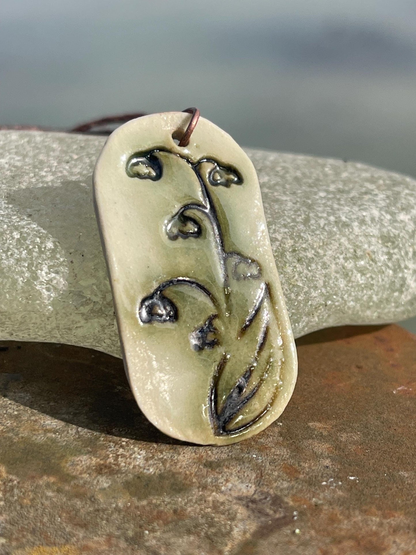 Handmade snowdrop necklace. Eco friendly jewellery. Ethical pendants made with waste clay and burnt recycled copper. Ethical jewellery.