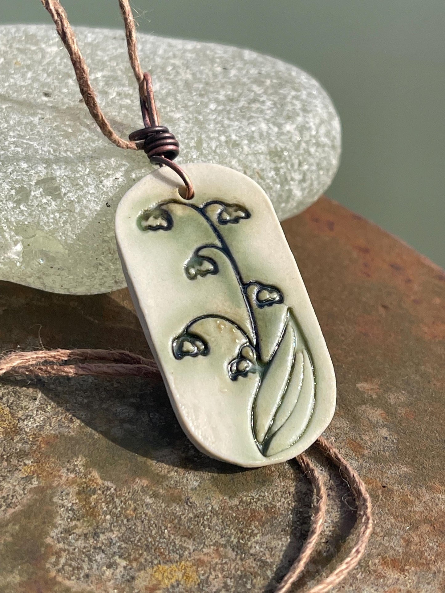 Handmade snowdrop necklace. Eco friendly jewellery. Ethical pendants made with waste clay and burnt recycled copper. Ethical jewellery.