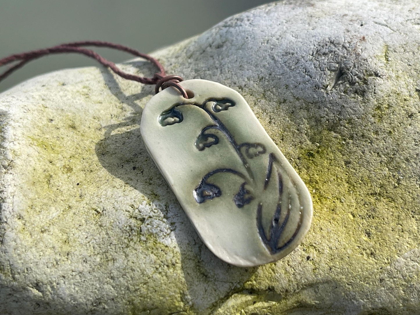 Handmade snowdrop necklace. Eco friendly jewellery. Ethical pendants made with waste clay and burnt recycled copper. Ethical jewellery.