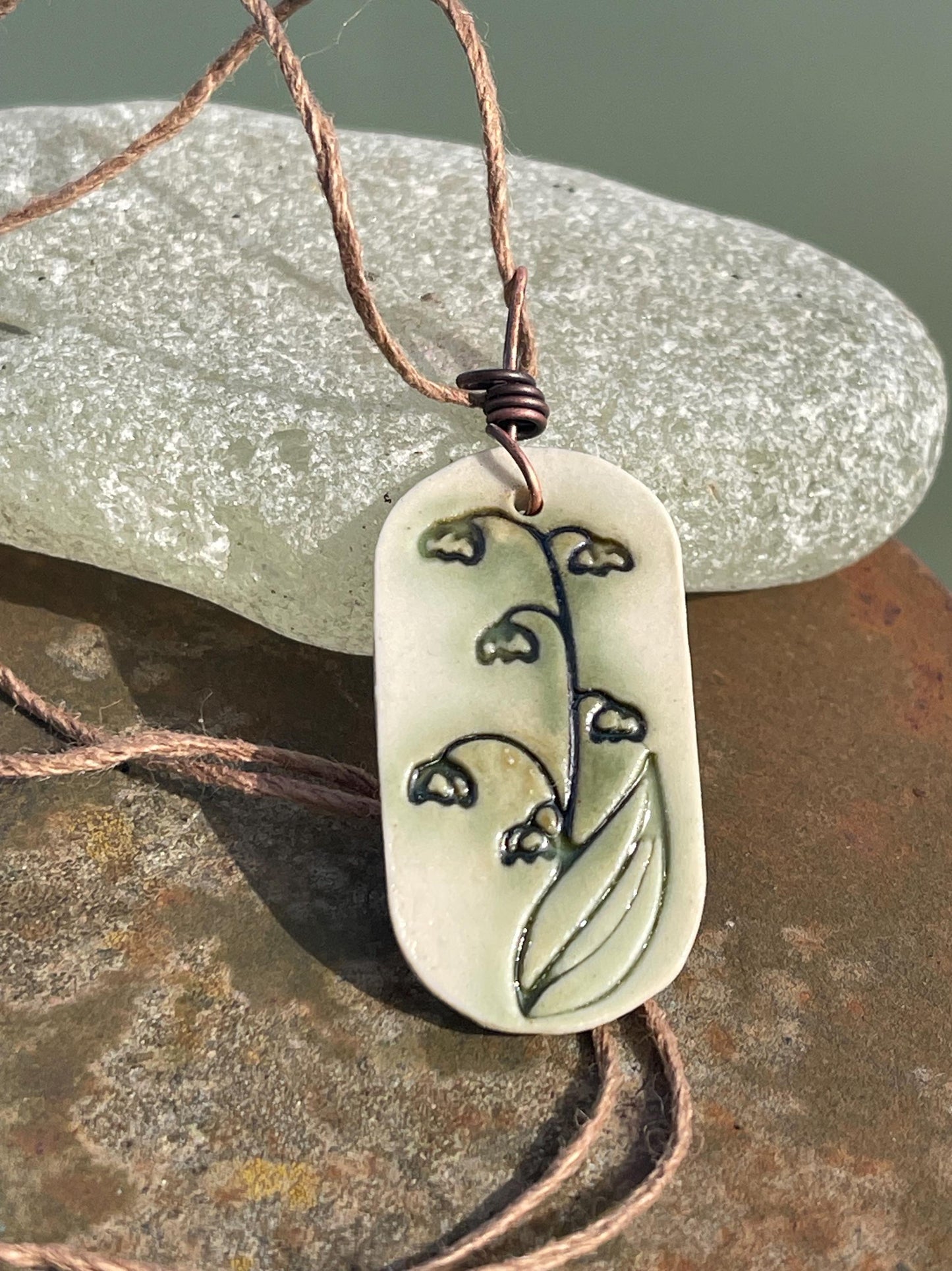 Handmade snowdrop necklace. Eco friendly jewellery. Ethical pendants made with waste clay and burnt recycled copper. Ethical jewellery.