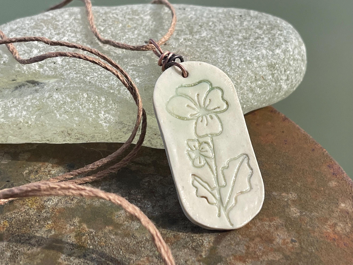 Handmade Poppy necklace. Eco friendly jewellery. Ethical pendants made with waste clay and burnt recycled copper. Ethical jewellery.