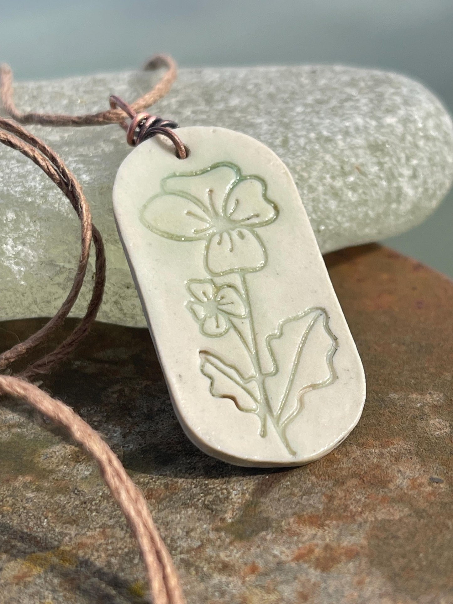 Handmade Poppy necklace. Eco friendly jewellery. Ethical pendants made with waste clay and burnt recycled copper. Ethical jewellery.