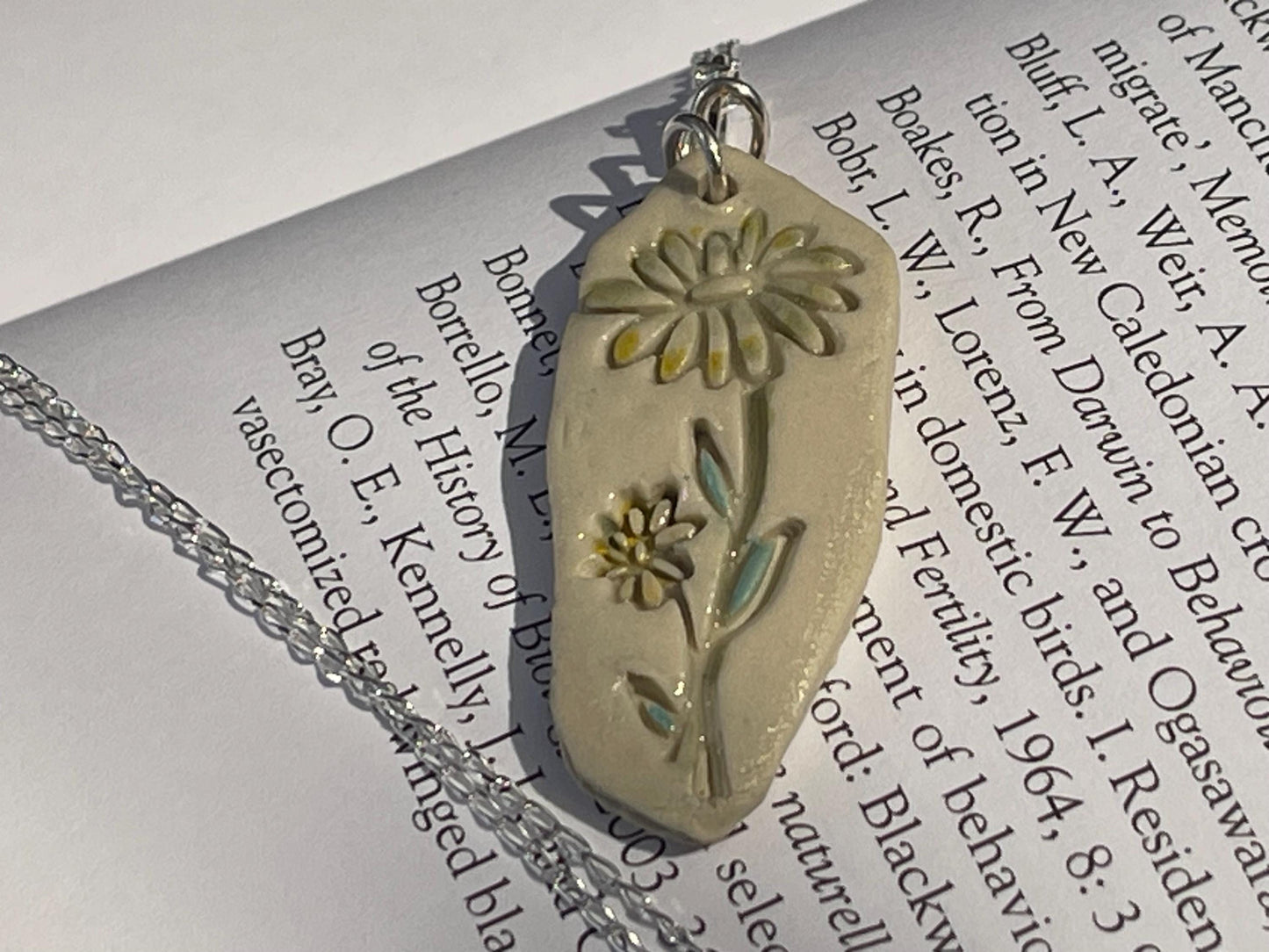 Handmade daisy necklace. Eco friendly jewellery. Ethical pendants made with waste clay and recycled sterling silver. Ethical jewellery.