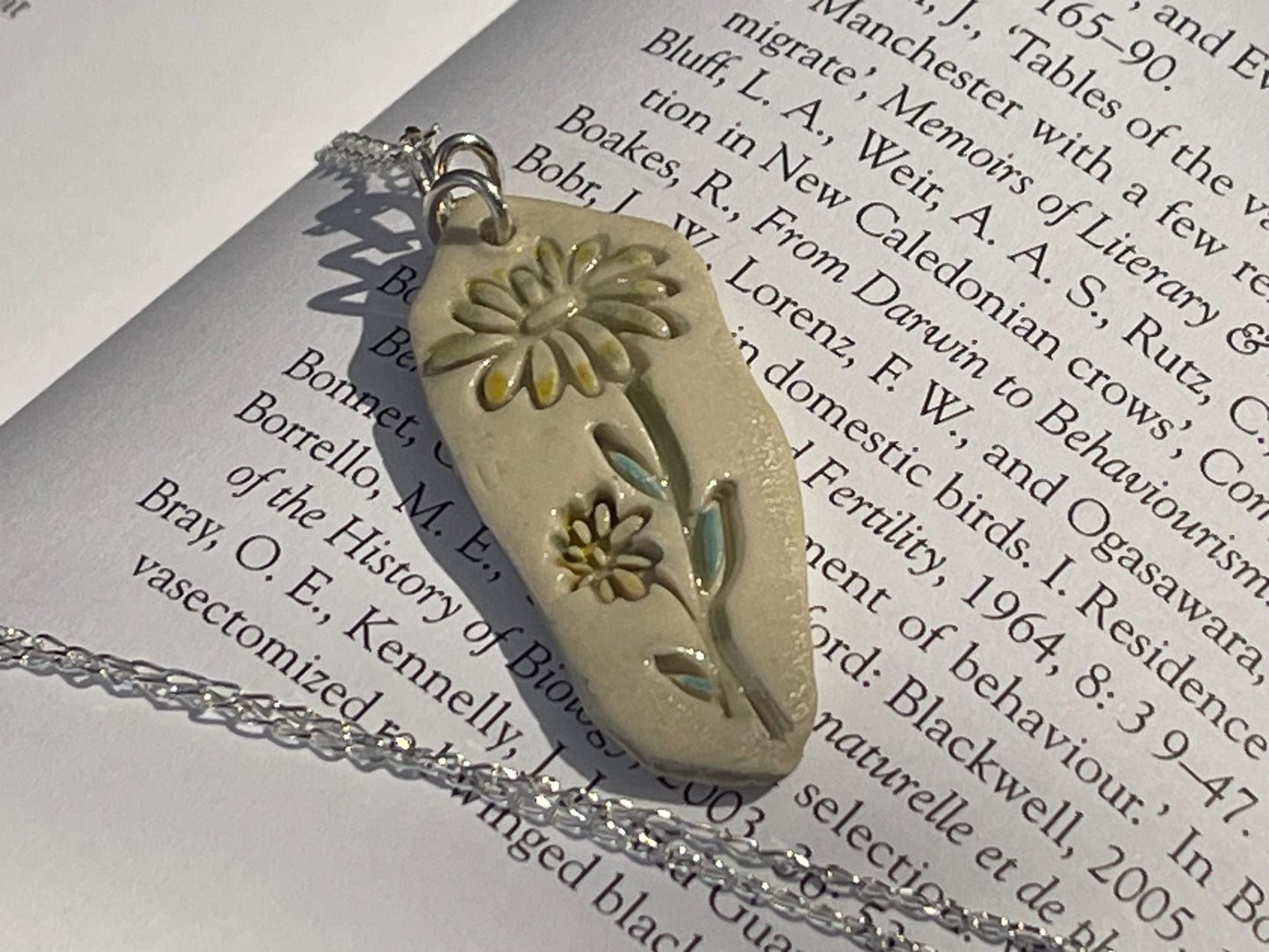 Handmade daisy necklace. Eco friendly jewellery. Ethical pendants made with waste clay and recycled sterling silver. Ethical jewellery.