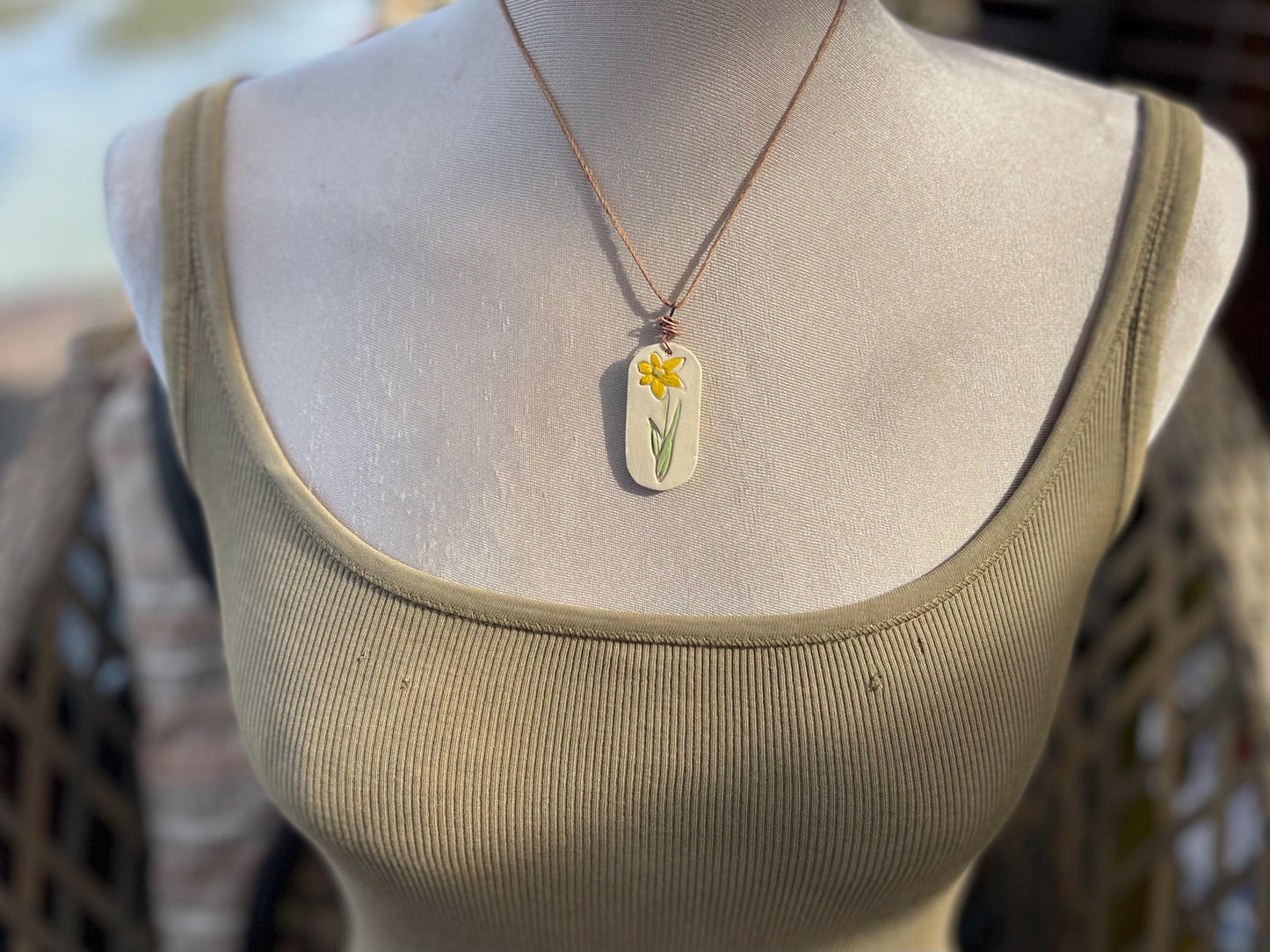 Handmade daffodil necklace. Eco friendly jewellery. Ethical pendants made with waste clay and burnt recycled copper. Ethical jewellery.