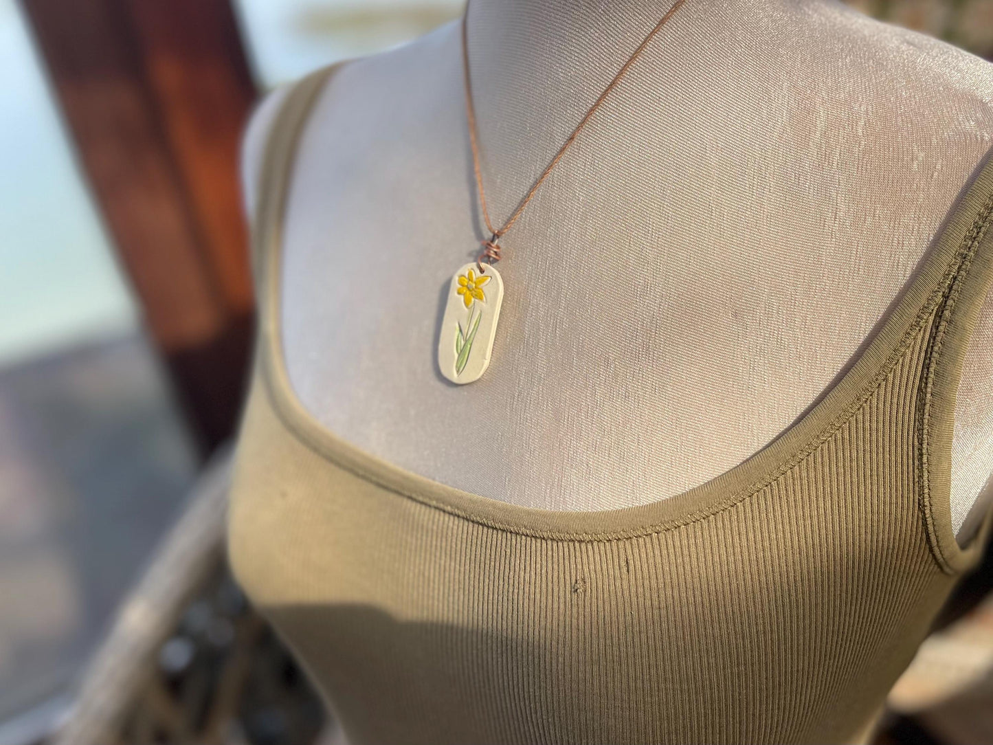 Handmade daffodil necklace. Eco friendly jewellery. Ethical pendants made with waste clay and burnt recycled copper. Ethical jewellery.