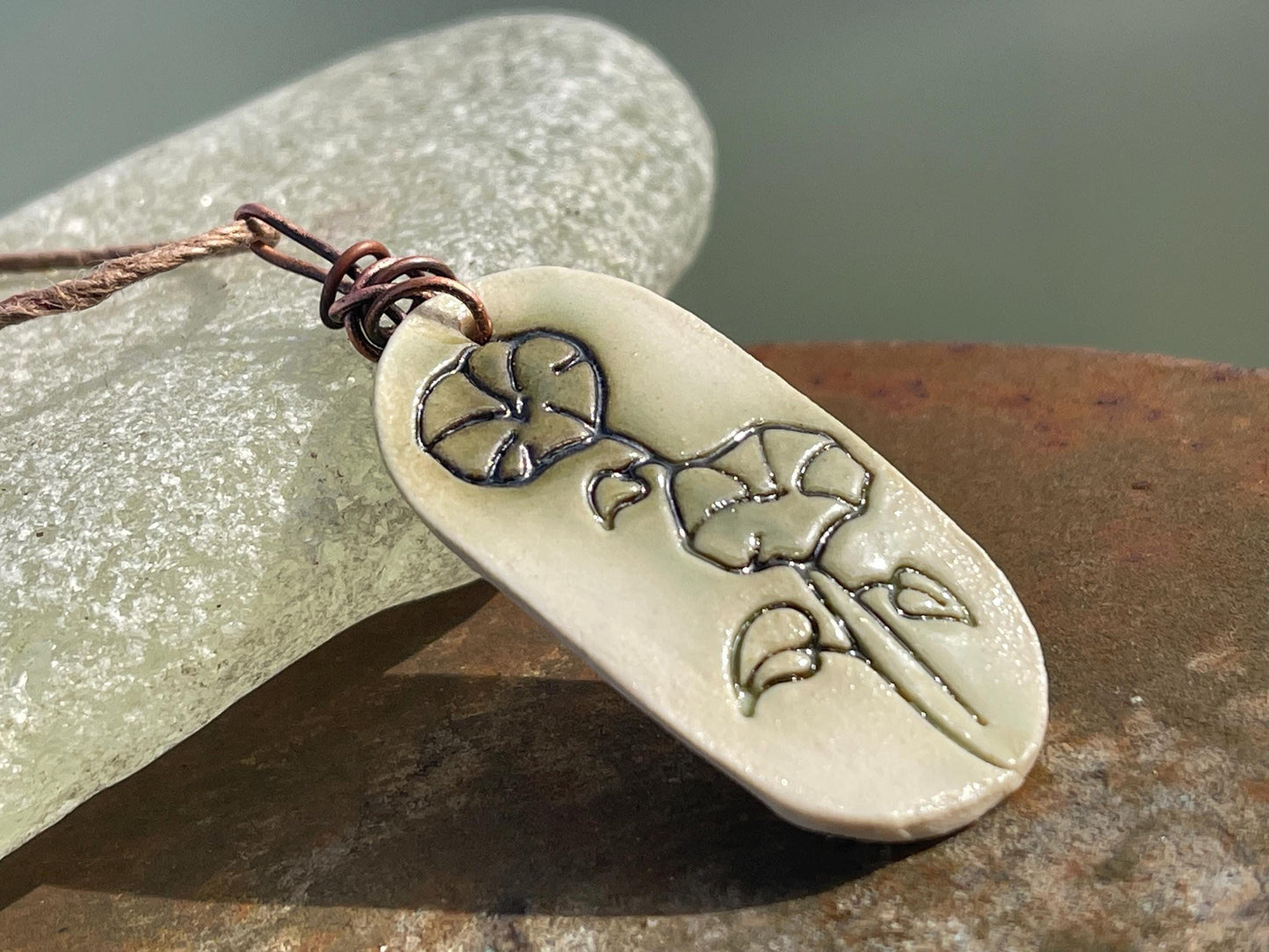 Handmade morning glory necklace. Eco friendly jewellery. Ethical pendants made with waste clay and burnt recycled copper. Ethical jewellery.