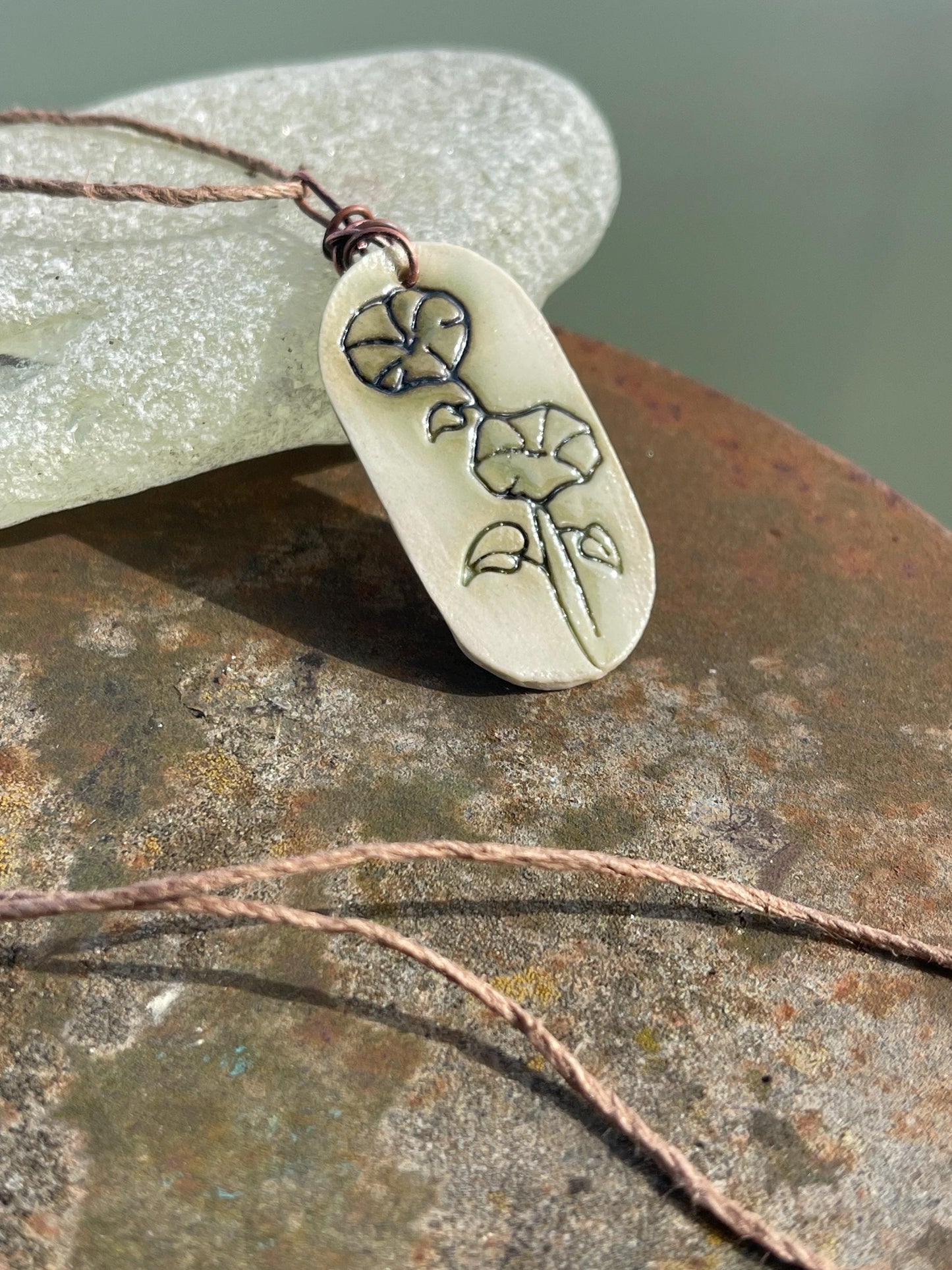 Handmade morning glory necklace. Eco friendly jewellery. Ethical pendants made with waste clay and burnt recycled copper. Ethical jewellery.