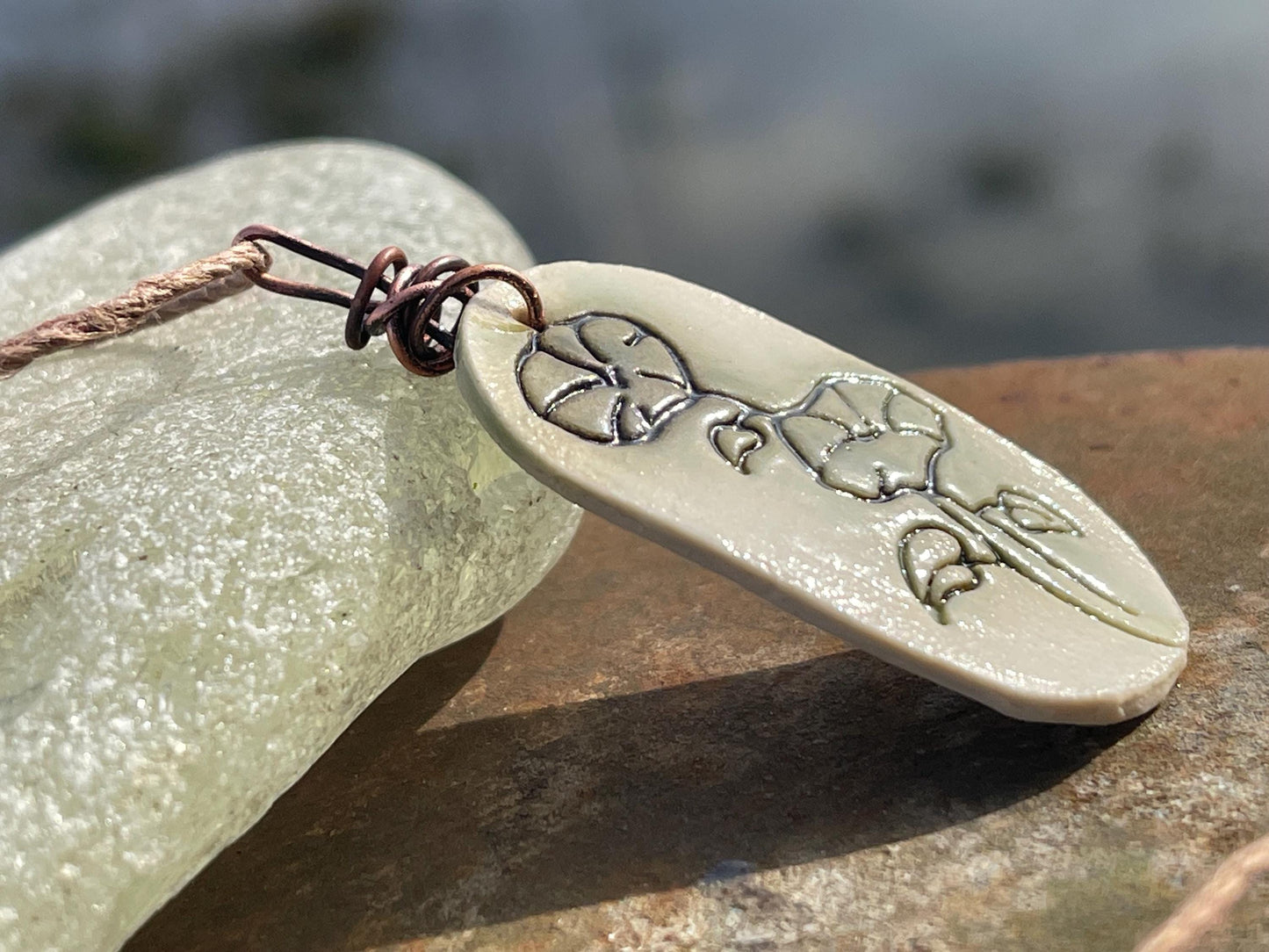 Handmade morning glory necklace. Eco friendly jewellery. Ethical pendants made with waste clay and burnt recycled copper. Ethical jewellery.