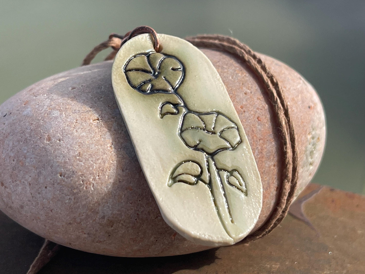 Handmade morning glory necklace. Eco friendly jewellery. Ethical pendants made with waste clay and burnt recycled copper. Ethical jewellery.