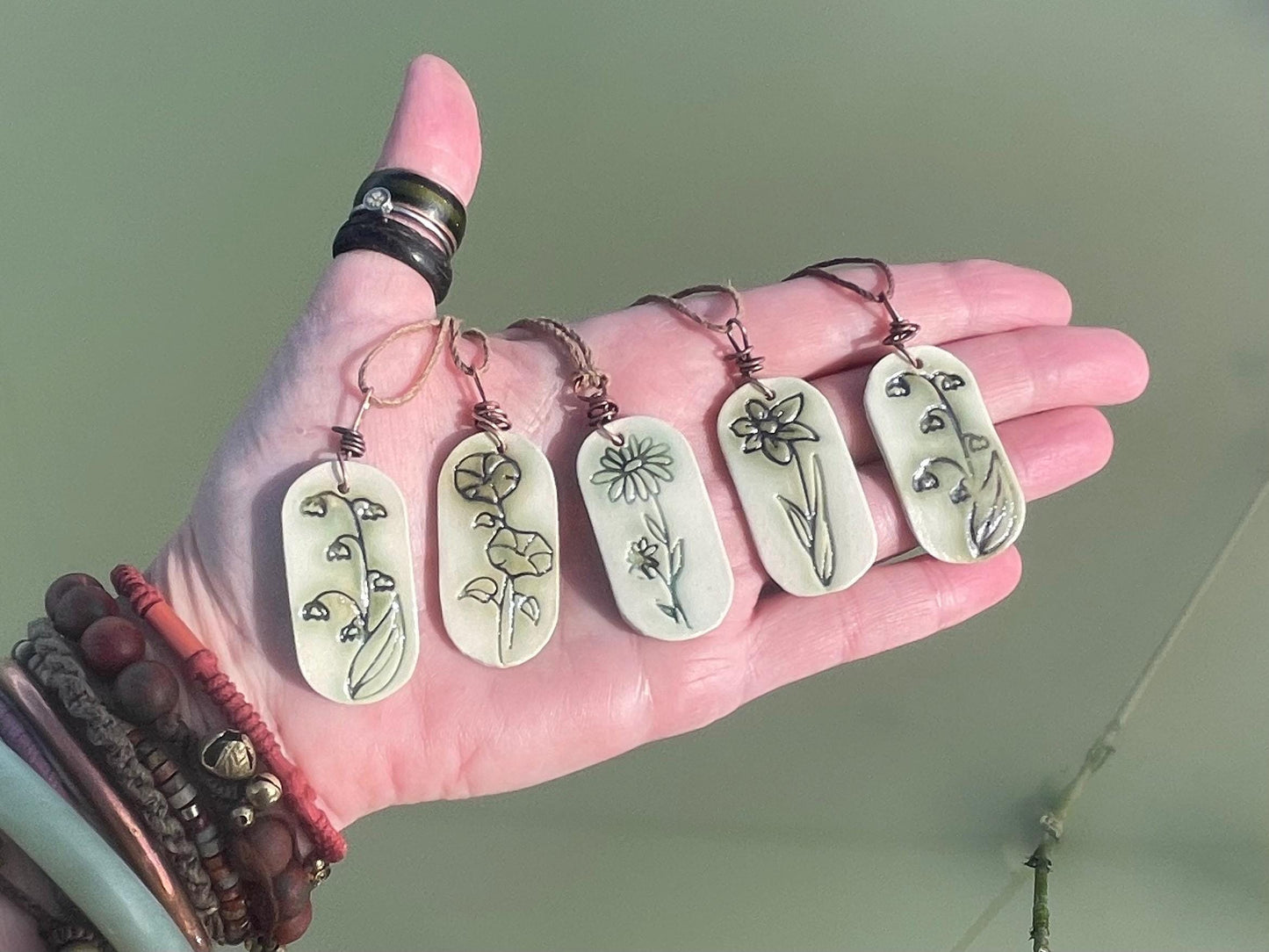 Handmade daffodil necklace. Eco friendly jewellery. Ethical pendants made with waste clay and burnt recycled copper. Ethical jewellery.