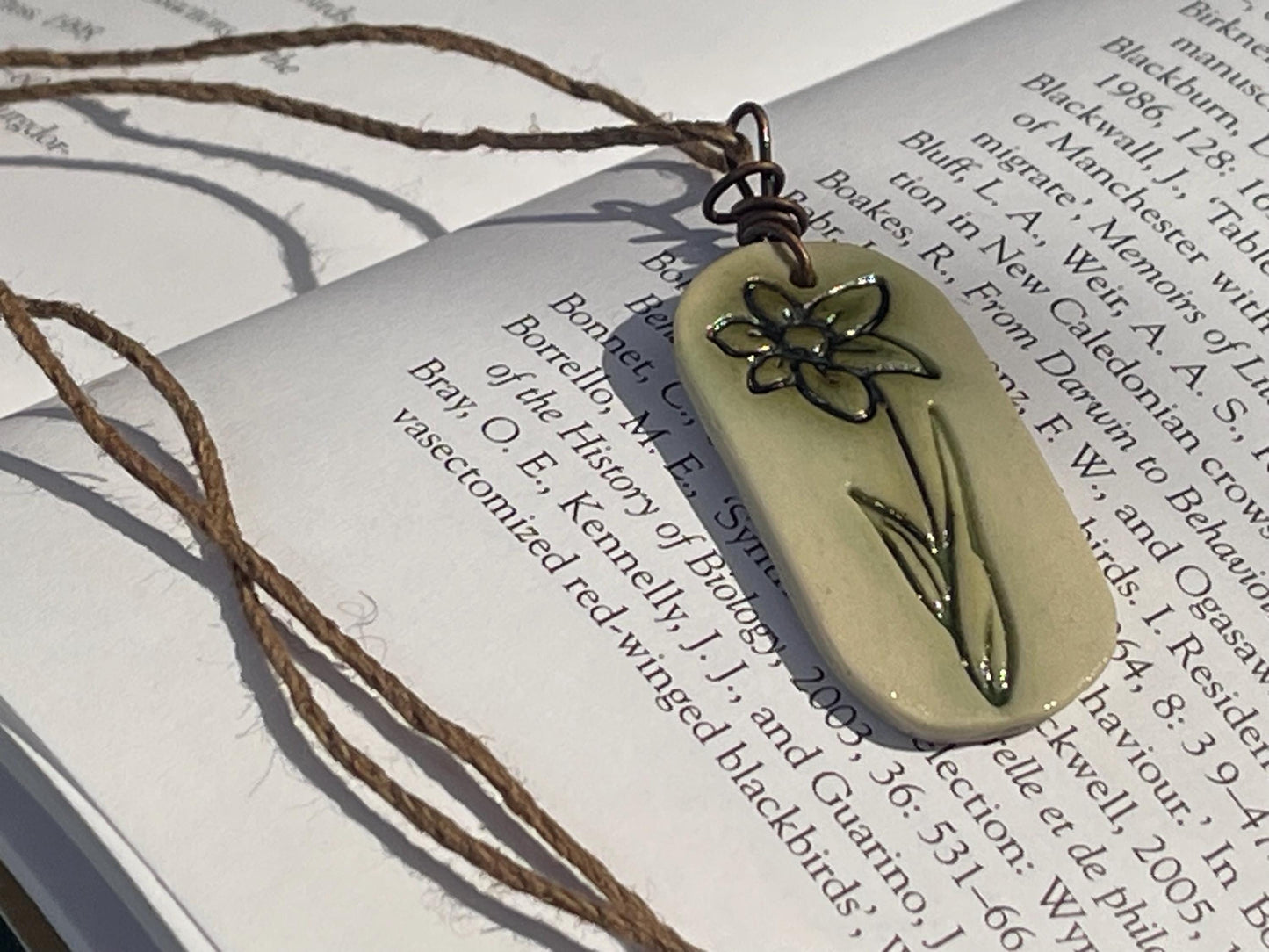 Handmade daffodil necklace. Eco friendly jewellery. Ethical pendants made with waste clay and burnt recycled copper. Ethical jewellery.