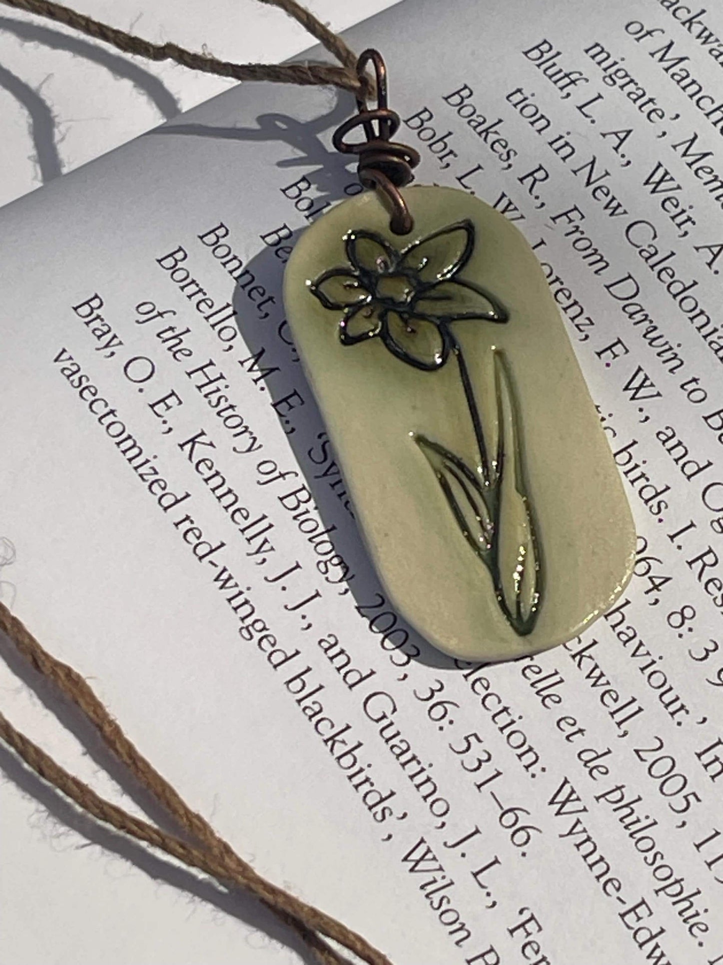 Handmade daffodil necklace. Eco friendly jewellery. Ethical pendants made with waste clay and burnt recycled copper. Ethical jewellery.