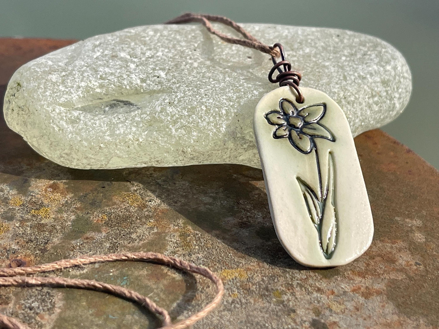 Handmade daffodil necklace. Eco friendly jewellery. Ethical pendants made with waste clay and burnt recycled copper. Ethical jewellery.