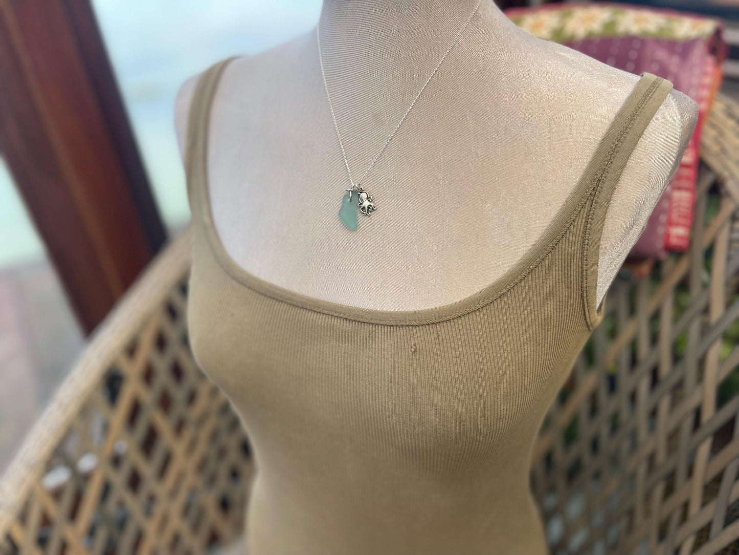 Eco friendly aqua sea glass necklace on a sterling silver chain showcasing a little octopus. Octopus pendant, eco friendly jewellery.