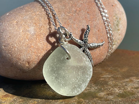 Eco friendly white sea glass necklace on a sterling silver chain showcasing a little starfish. Starfish pendant, eco friendly jewellery.
