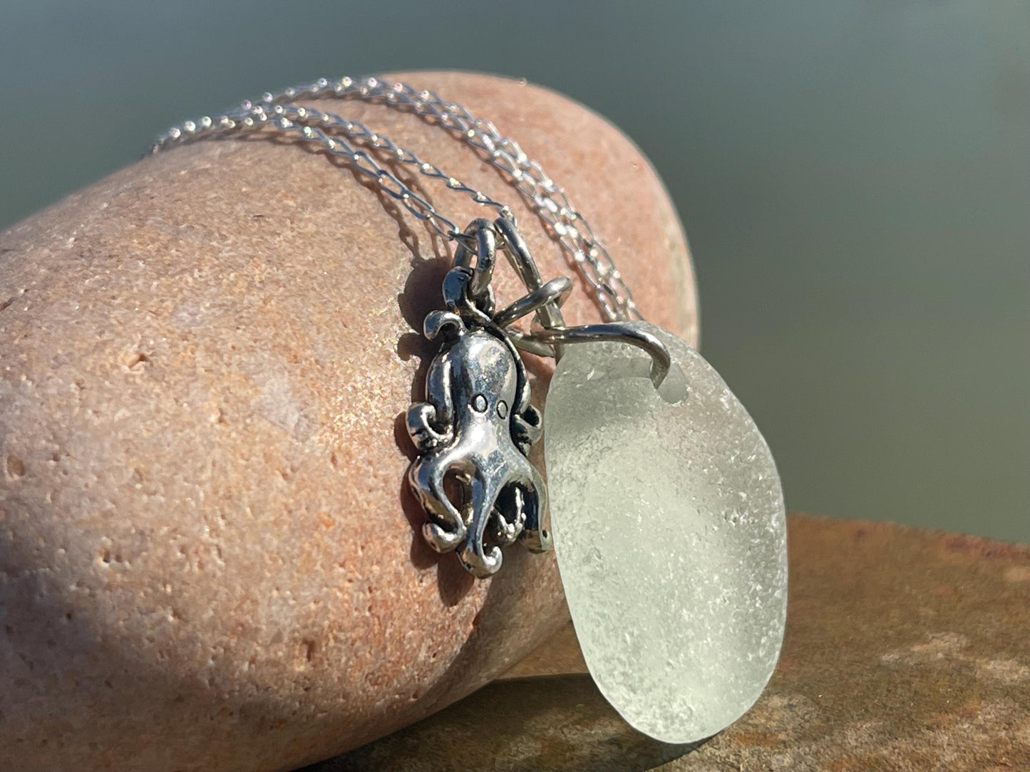 Eco friendly aqua sea glass necklace on a sterling silver chain showcasing a little octopus. Octopus pendant, eco friendly jewellery.