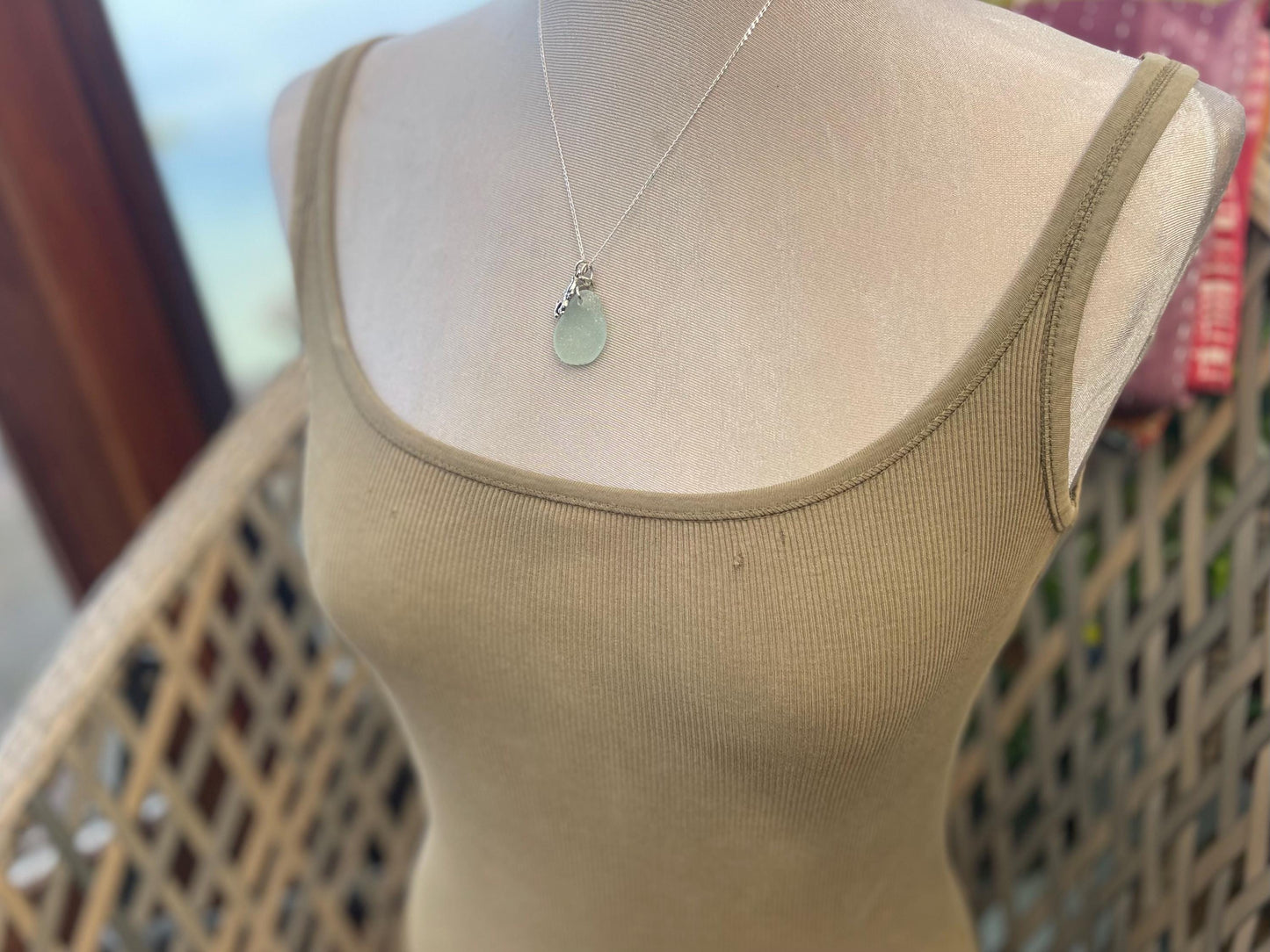 Eco friendly aqua sea glass necklace on a sterling silver chain showcasing a little octopus. Octopus pendant, eco friendly jewellery.