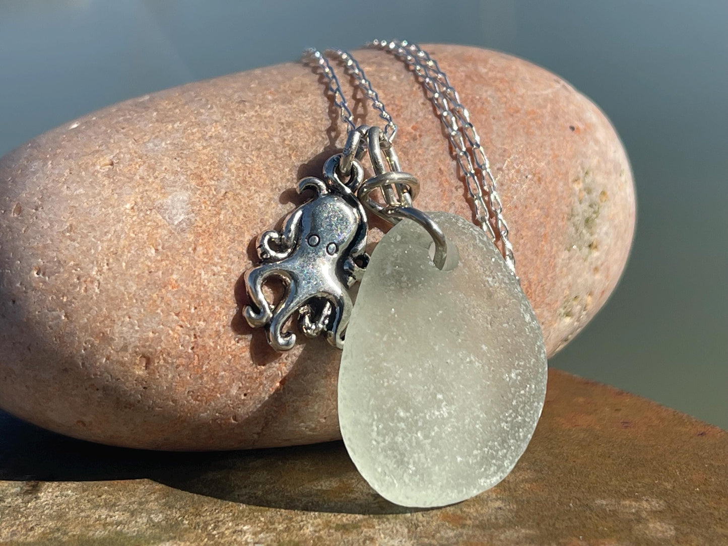 Eco friendly aqua sea glass necklace on a sterling silver chain showcasing a little octopus. Octopus pendant, eco friendly jewellery.