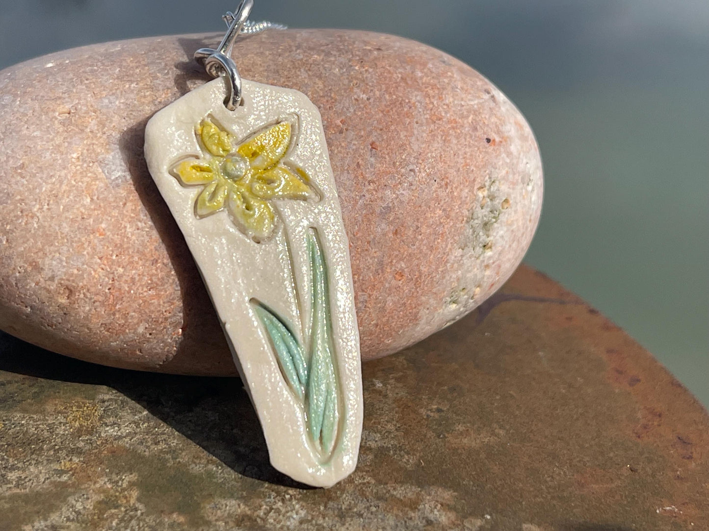 Handmade daffodil necklace. Eco friendly jewellery. Ethical pendants made with waste clay and recycled sterling silver. Ethical jewellery.