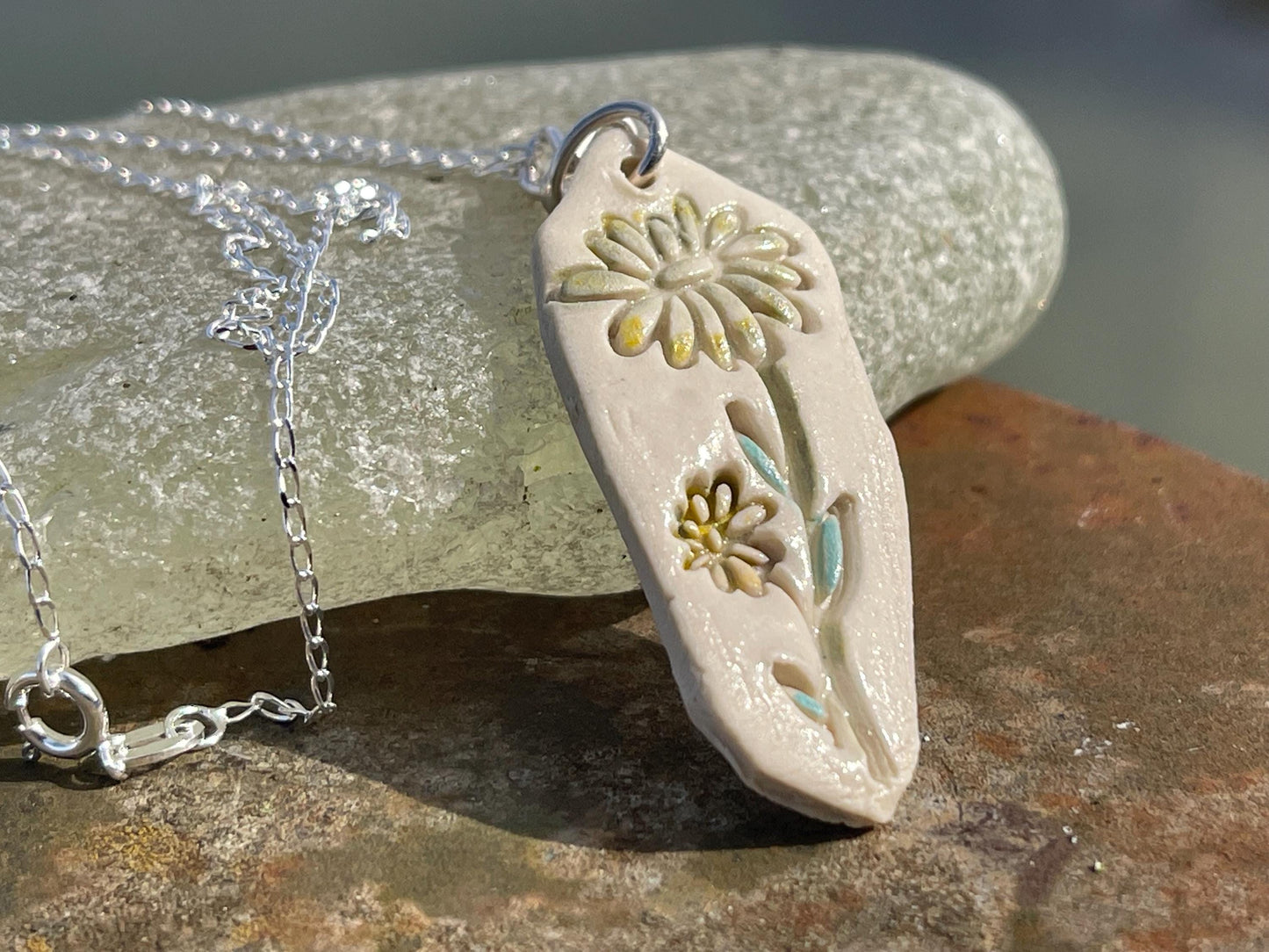 Handmade daisy necklace. Eco friendly jewellery. Ethical pendants made with waste clay and recycled sterling silver. Ethical jewellery.