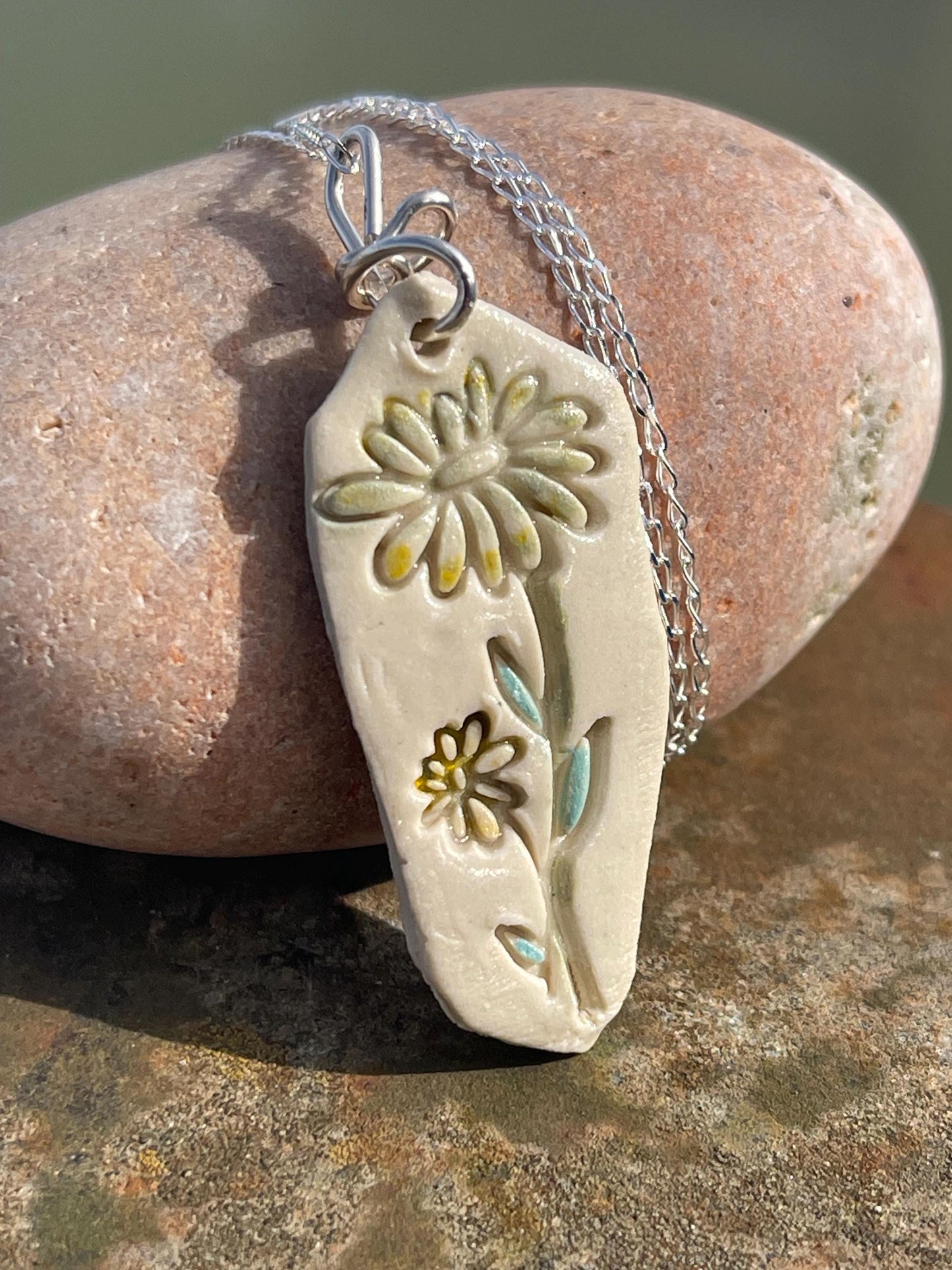 Handmade daisy necklace. Eco friendly jewellery. Ethical pendants made with waste clay and recycled sterling silver. Ethical jewellery.