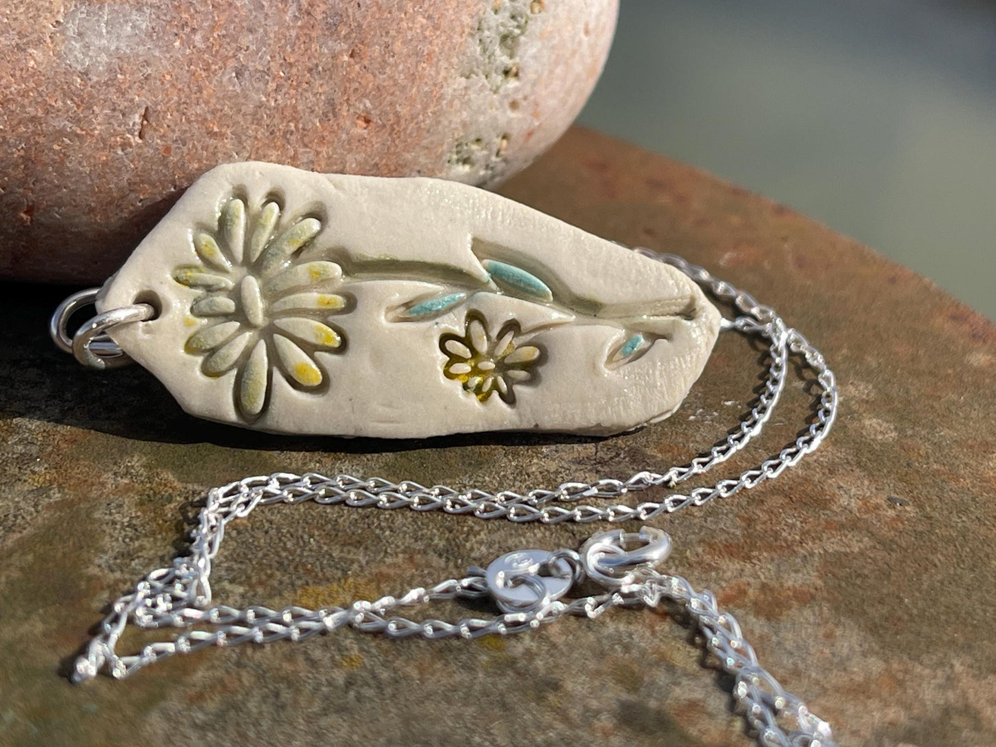 Handmade daisy necklace. Eco friendly jewellery. Ethical pendants made with waste clay and recycled sterling silver. Ethical jewellery.