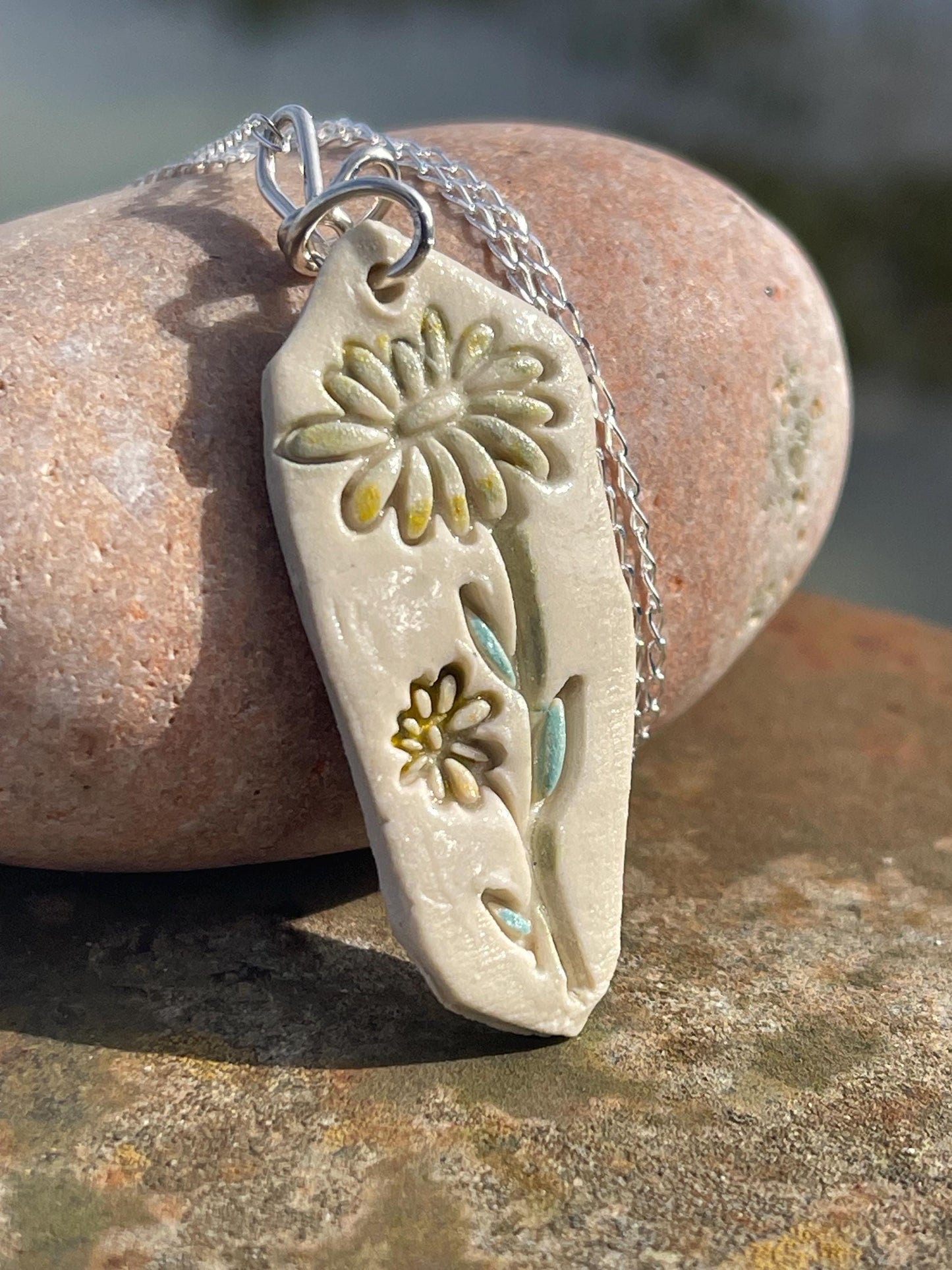 Handmade daisy necklace. Eco friendly jewellery. Ethical pendants made with waste clay and recycled sterling silver. Ethical jewellery.