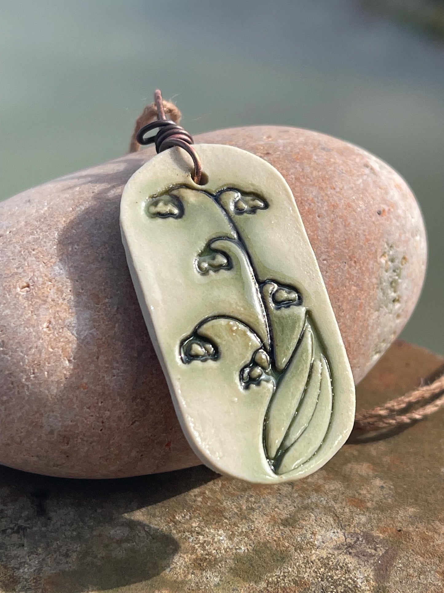 Handmade snowdrop necklace. Eco friendly jewellery. Ethical pendants made with waste clay and burnt recycled copper. Ethical jewellery.