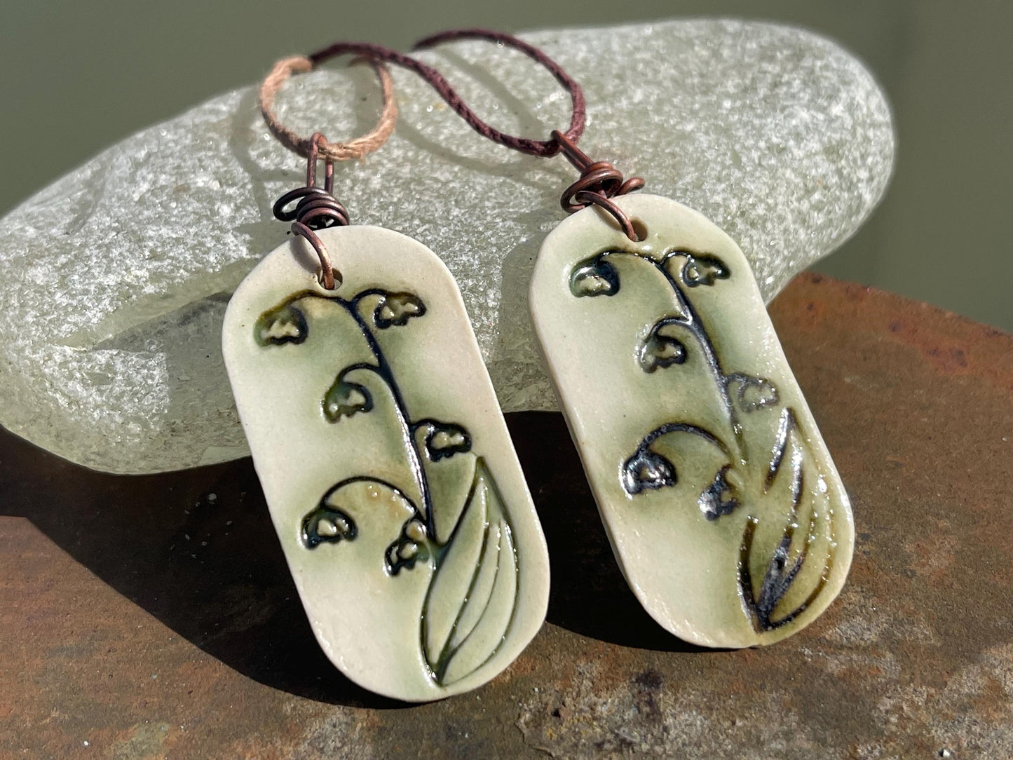 Handmade snowdrop necklace. Eco friendly jewellery. Ethical pendants made with waste clay and burnt recycled copper. Ethical jewellery.